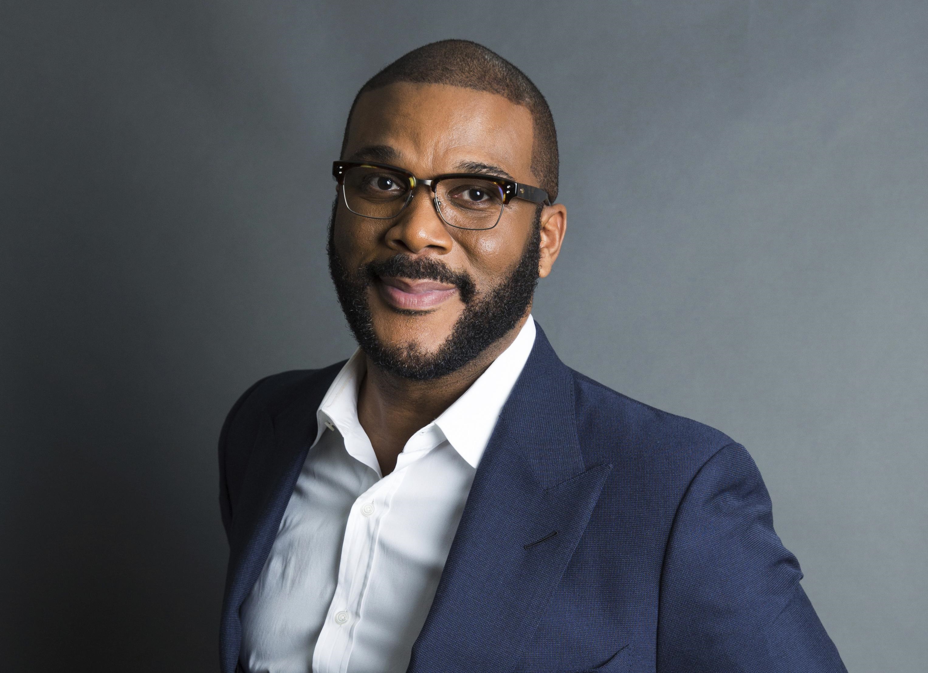 Tyler Perry wearing a suit and glasses HD Wallpaper