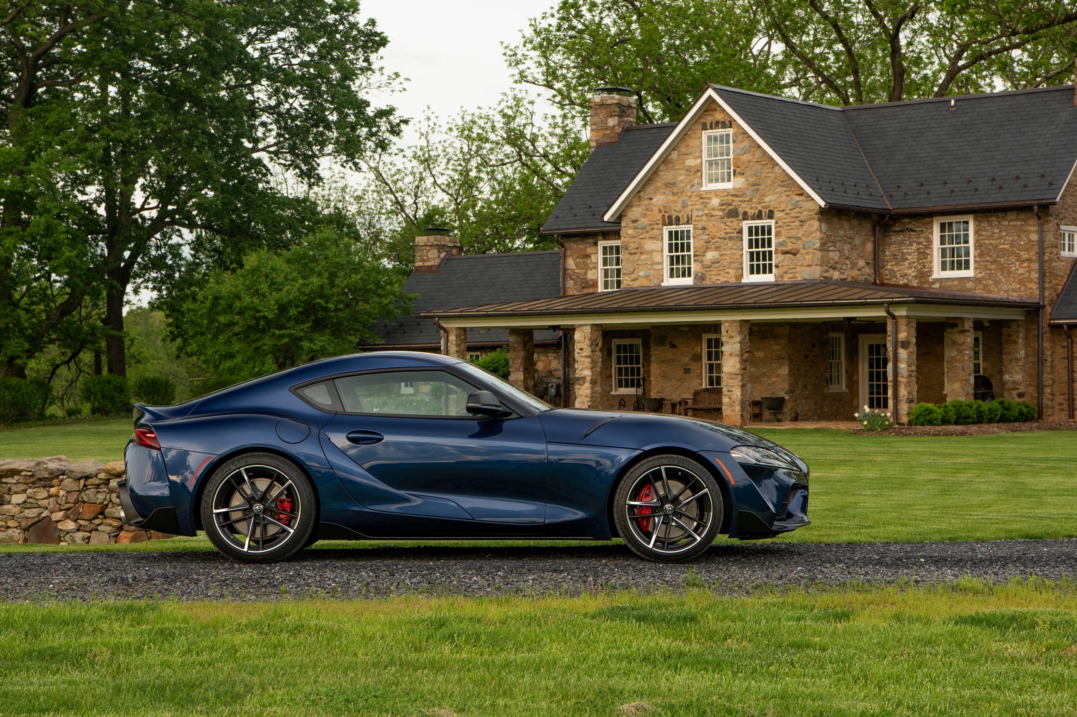 Blue Toyota Supra parked in front of stone house HD Wallpaper