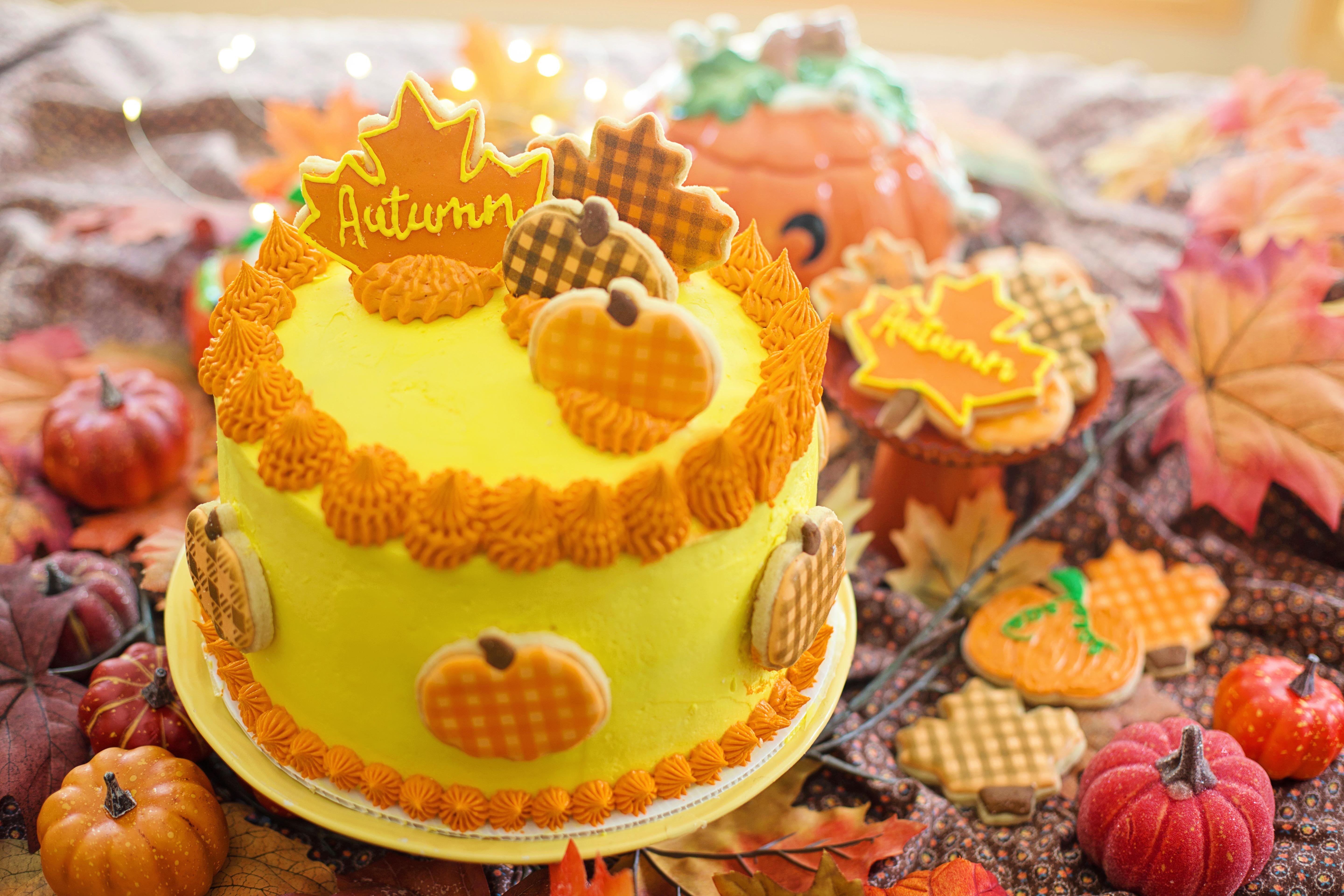 Autumn themed yellow cake with pumpkin and leaf decorations HD Wallpaper