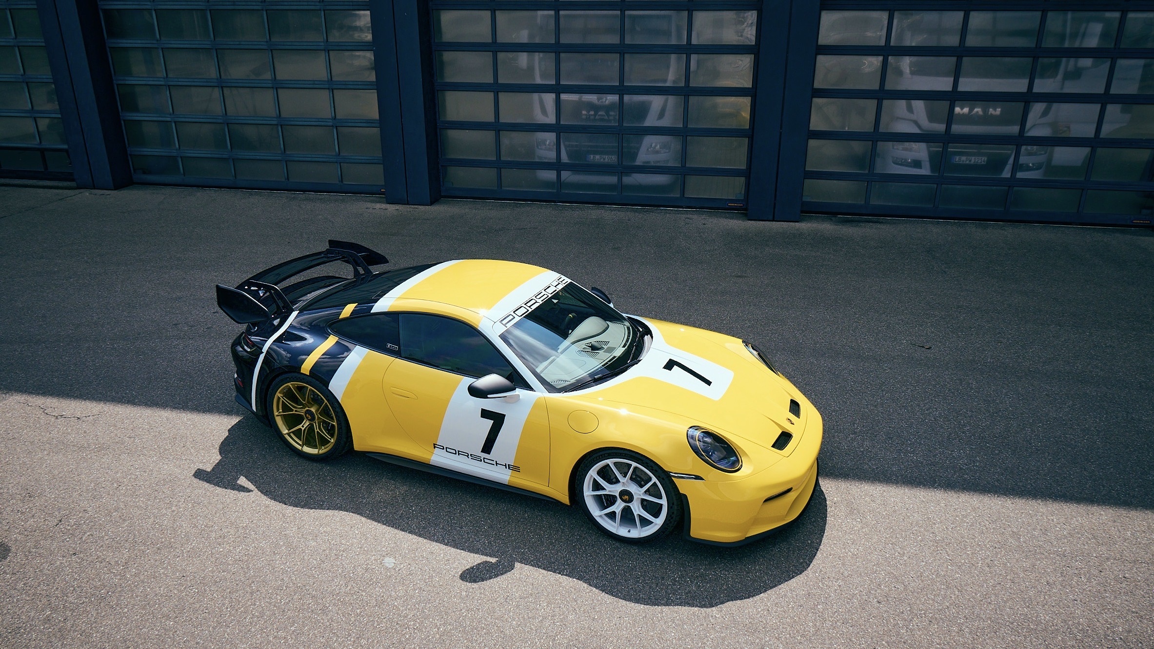 Yellow and black Porsche 911 GT3 with racing livery HD Wallpaper