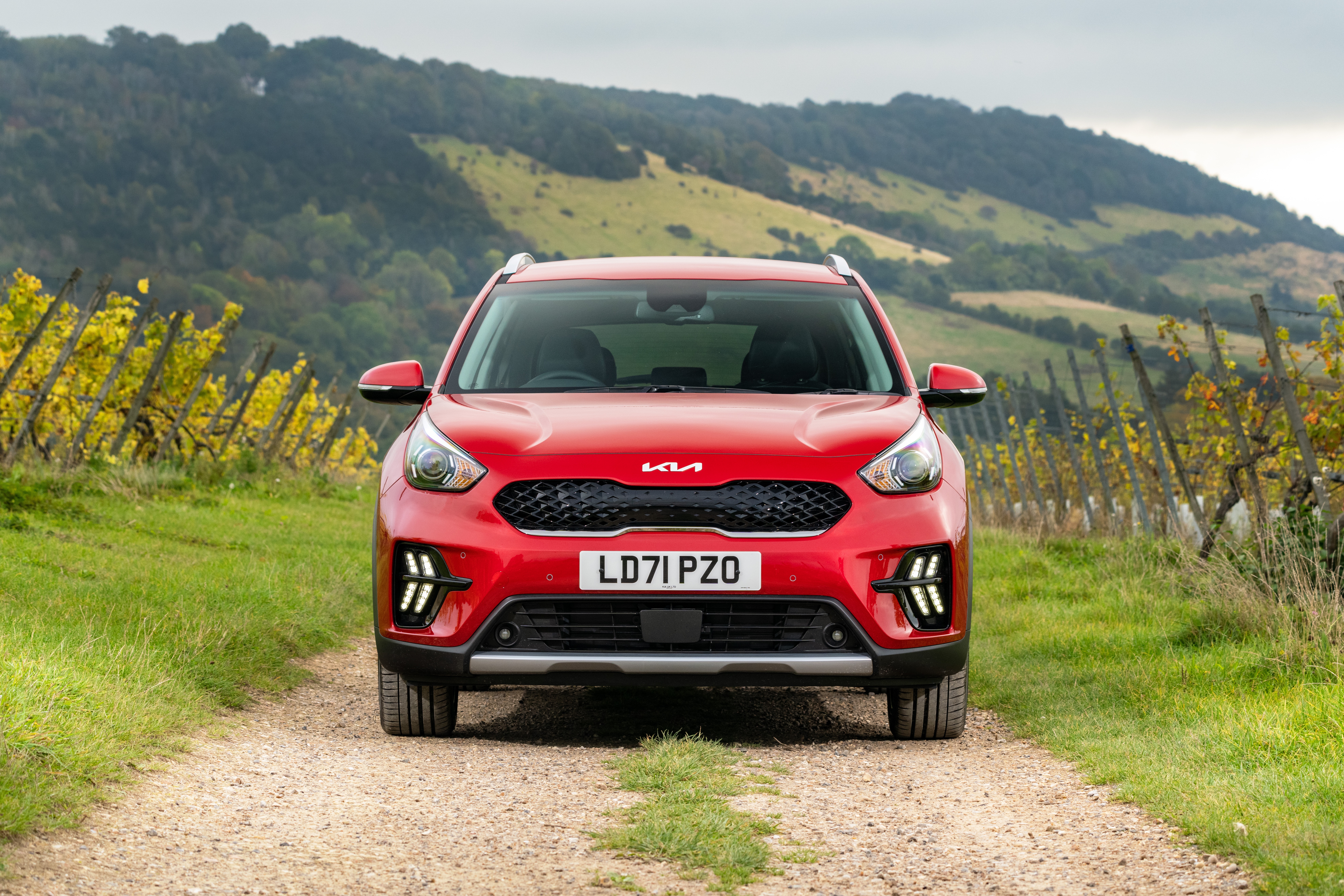 Red Kia Niro SUV on a dirt road HD Wallpaper