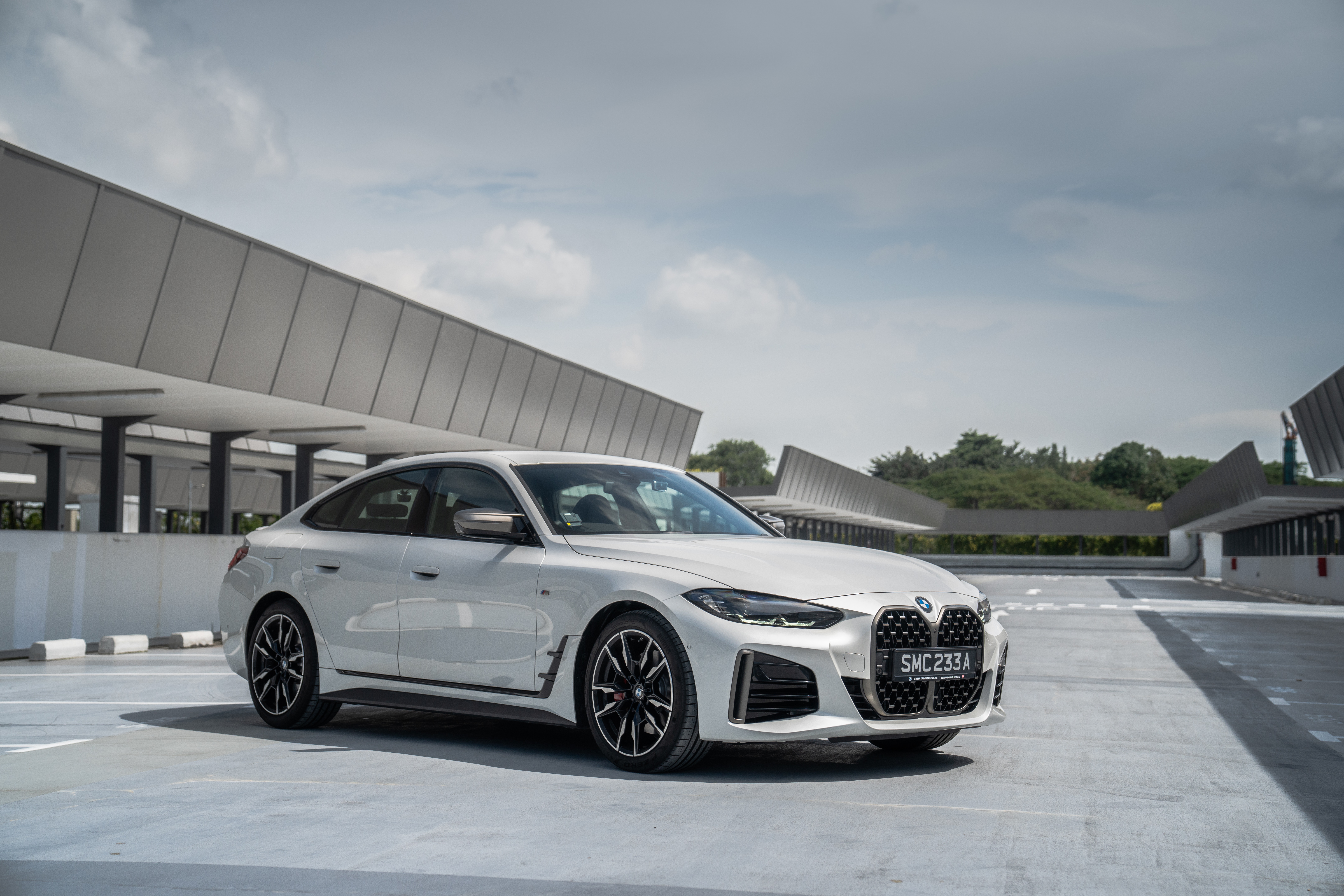 White BMW M440i xDrive Gran Coupé parked outdoors HD Wallpaper
