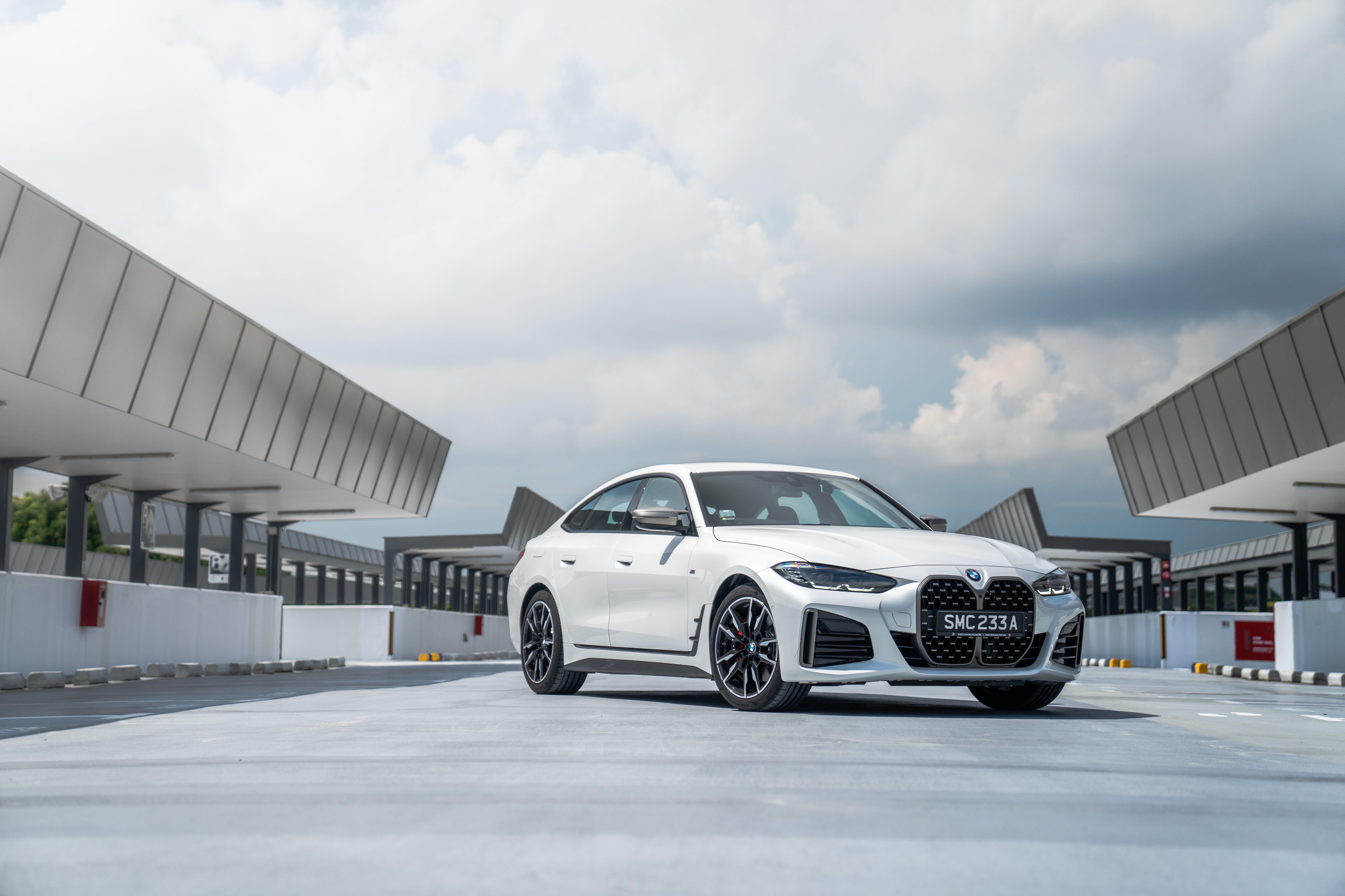 White BMW M440i xDrive Gran Coupé parked outdoors HD Wallpaper
