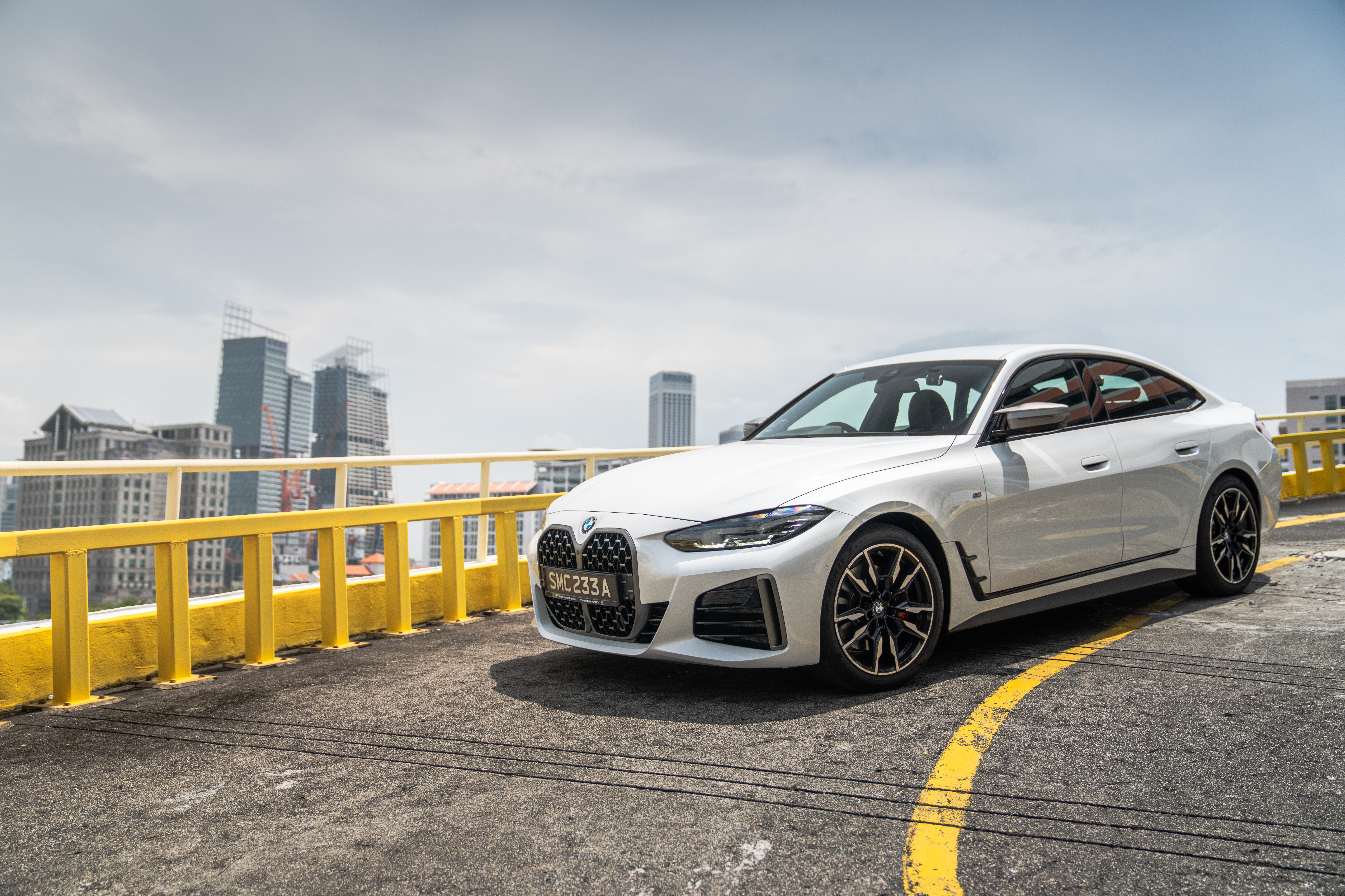White BMW M440i xDrive Gran Coupé in city HD Wallpaper