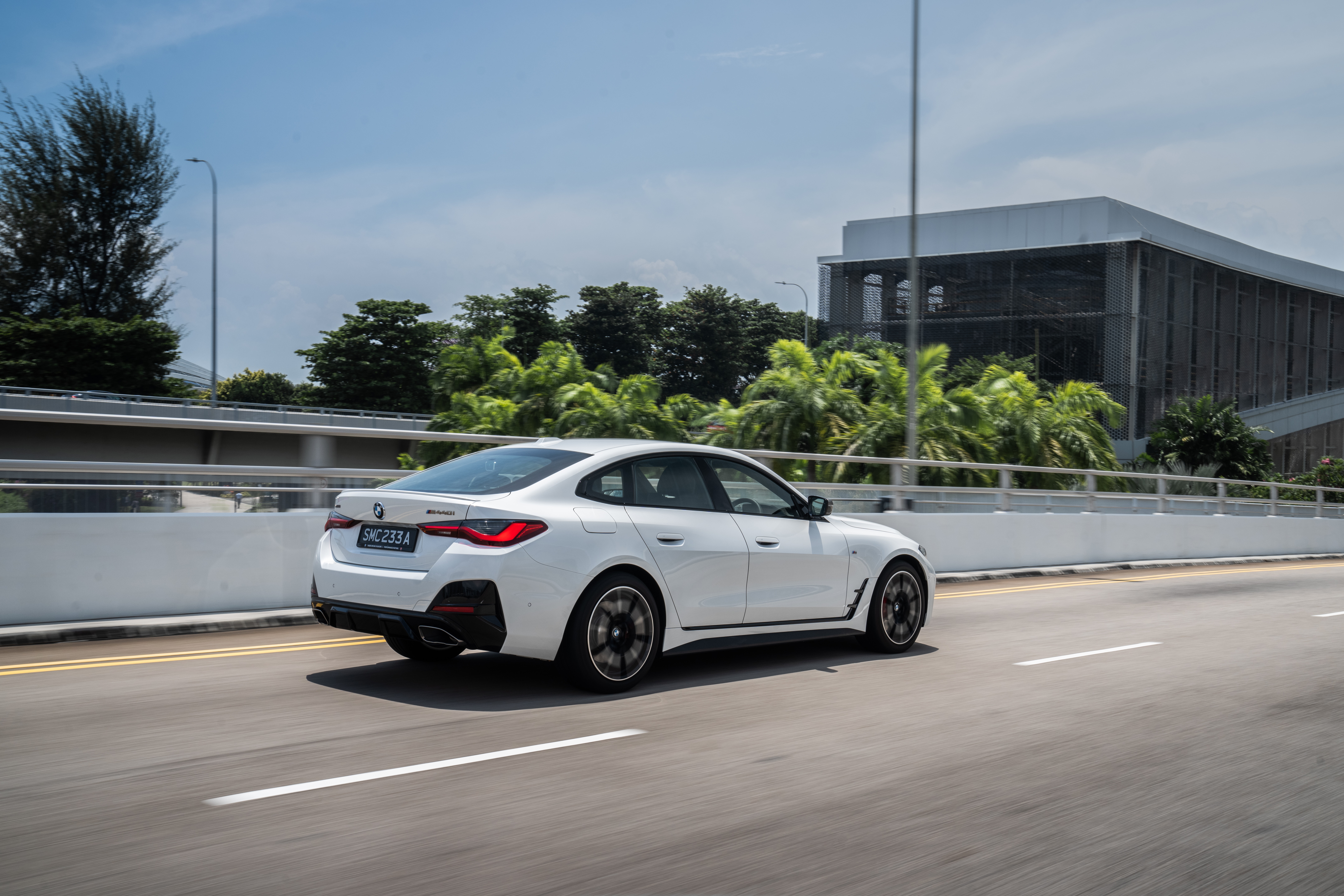 White BMW M440i xDrive Gran Coupé driving on road HD Wallpaper