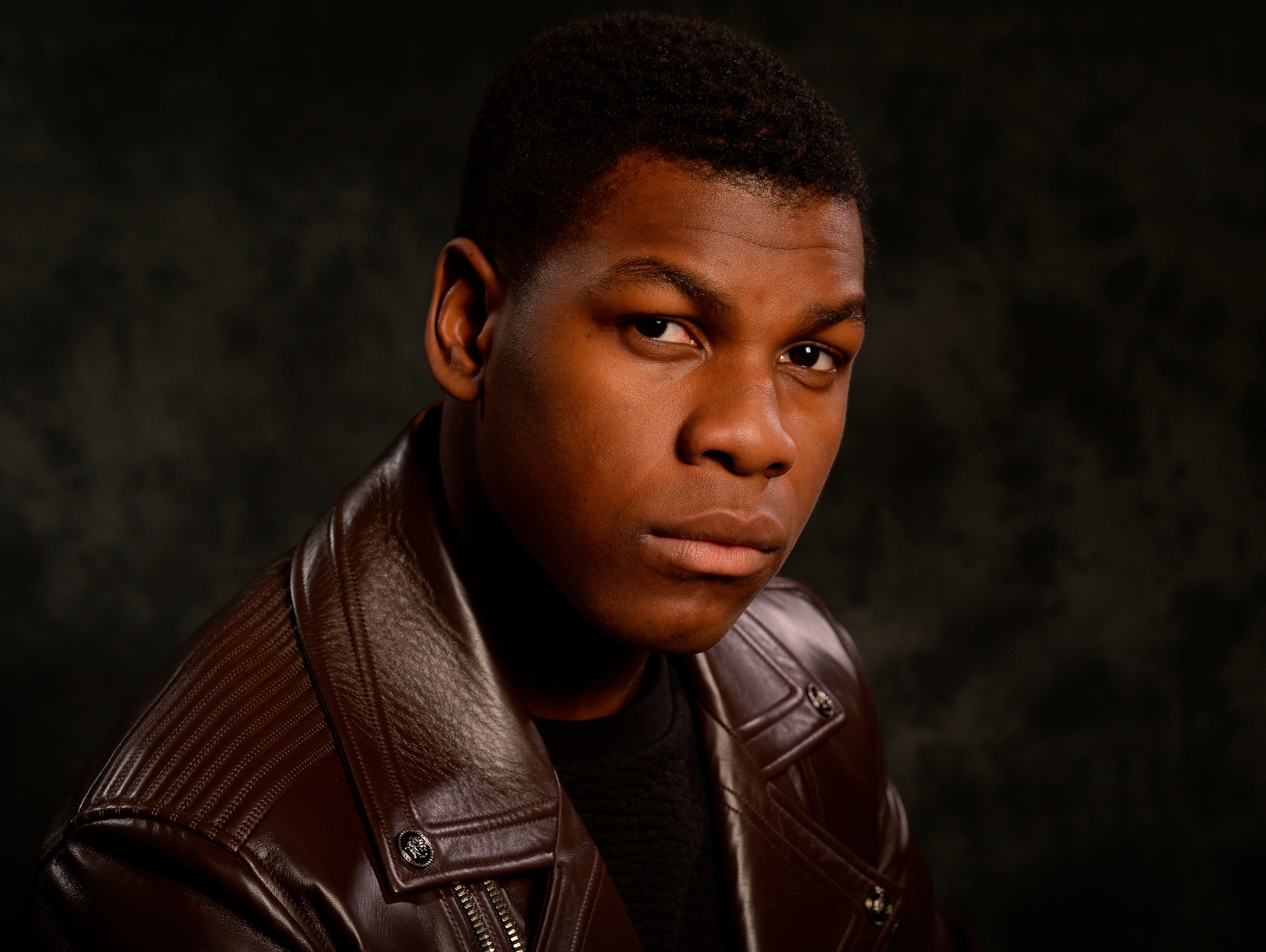 John Boyega in a brown leather jacket HD Wallpaper