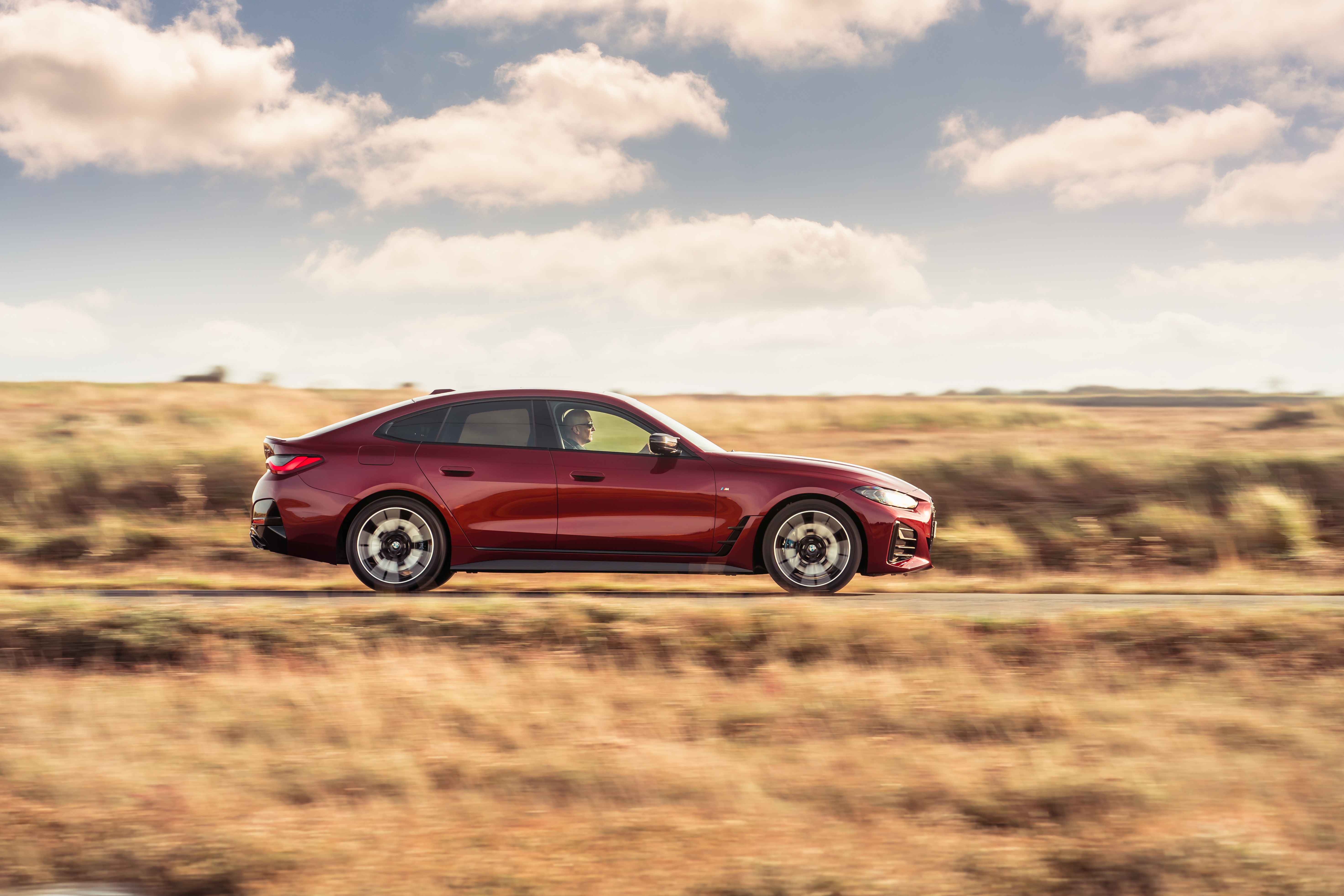 BMW M440i xDrive Gran Coupé driving on a road HD Wallpaper