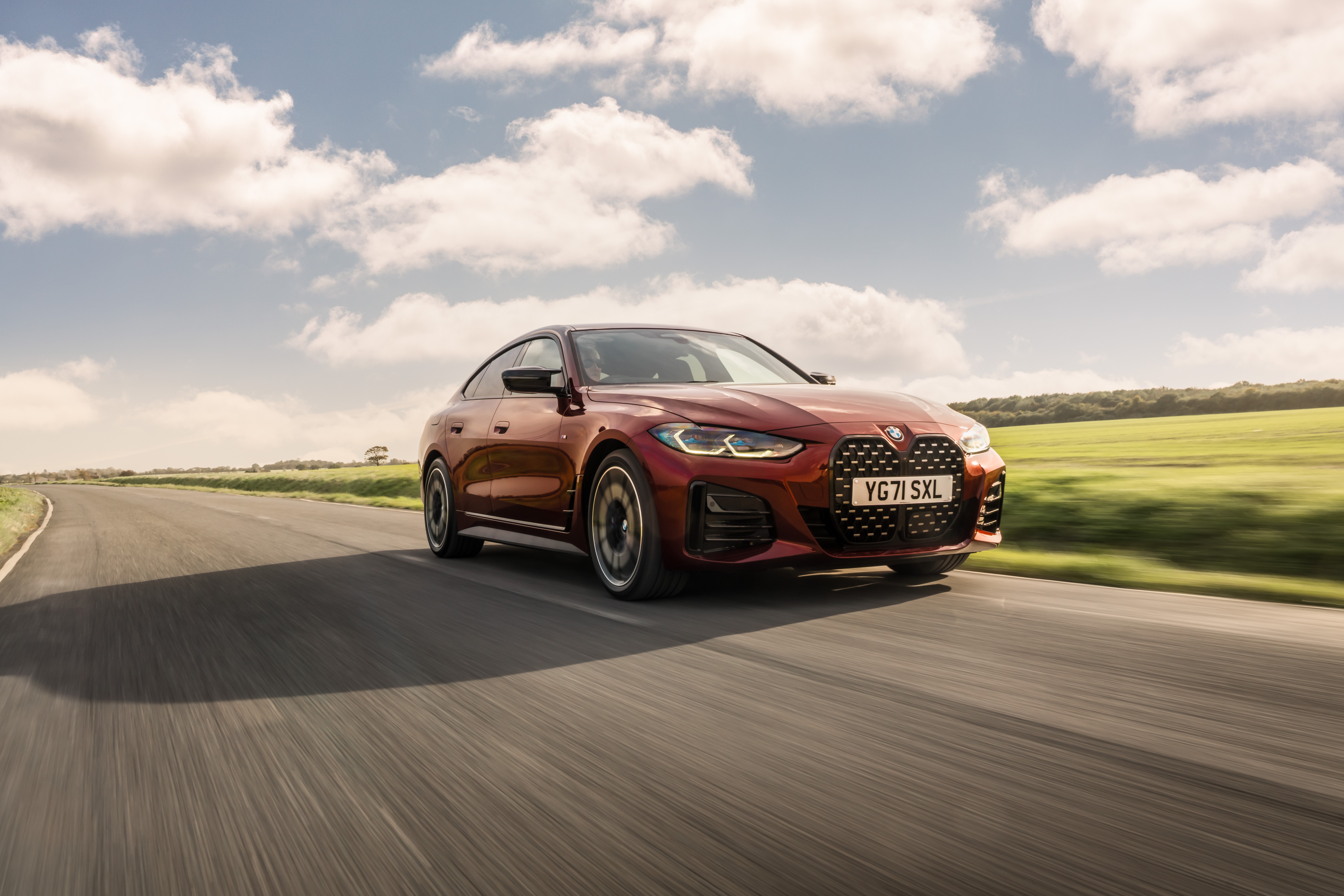 BMW M440i xDrive Gran Coupé on a road HD Wallpaper