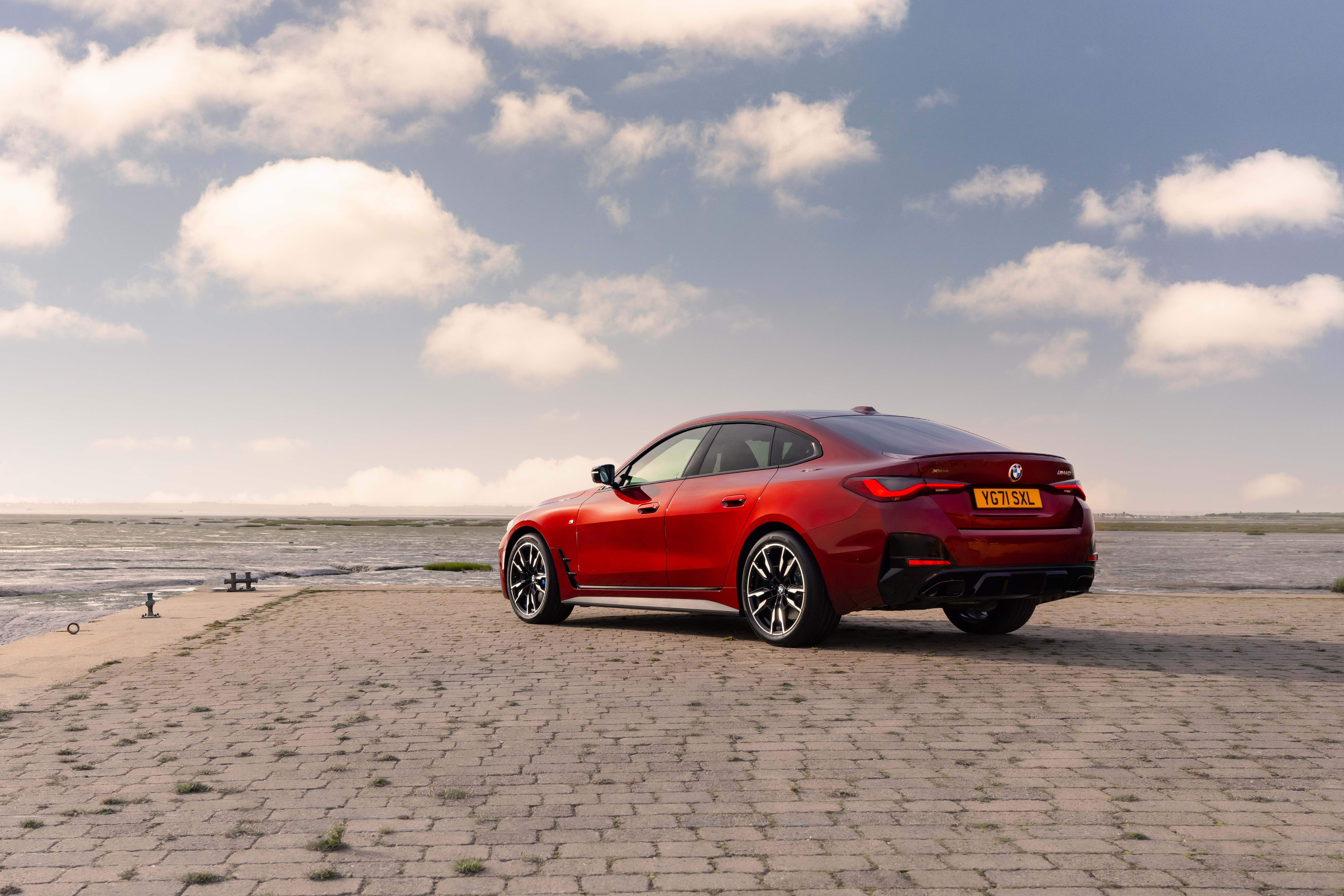 Red BMW M440i xDrive Gran Coupé by the water HD Wallpaper