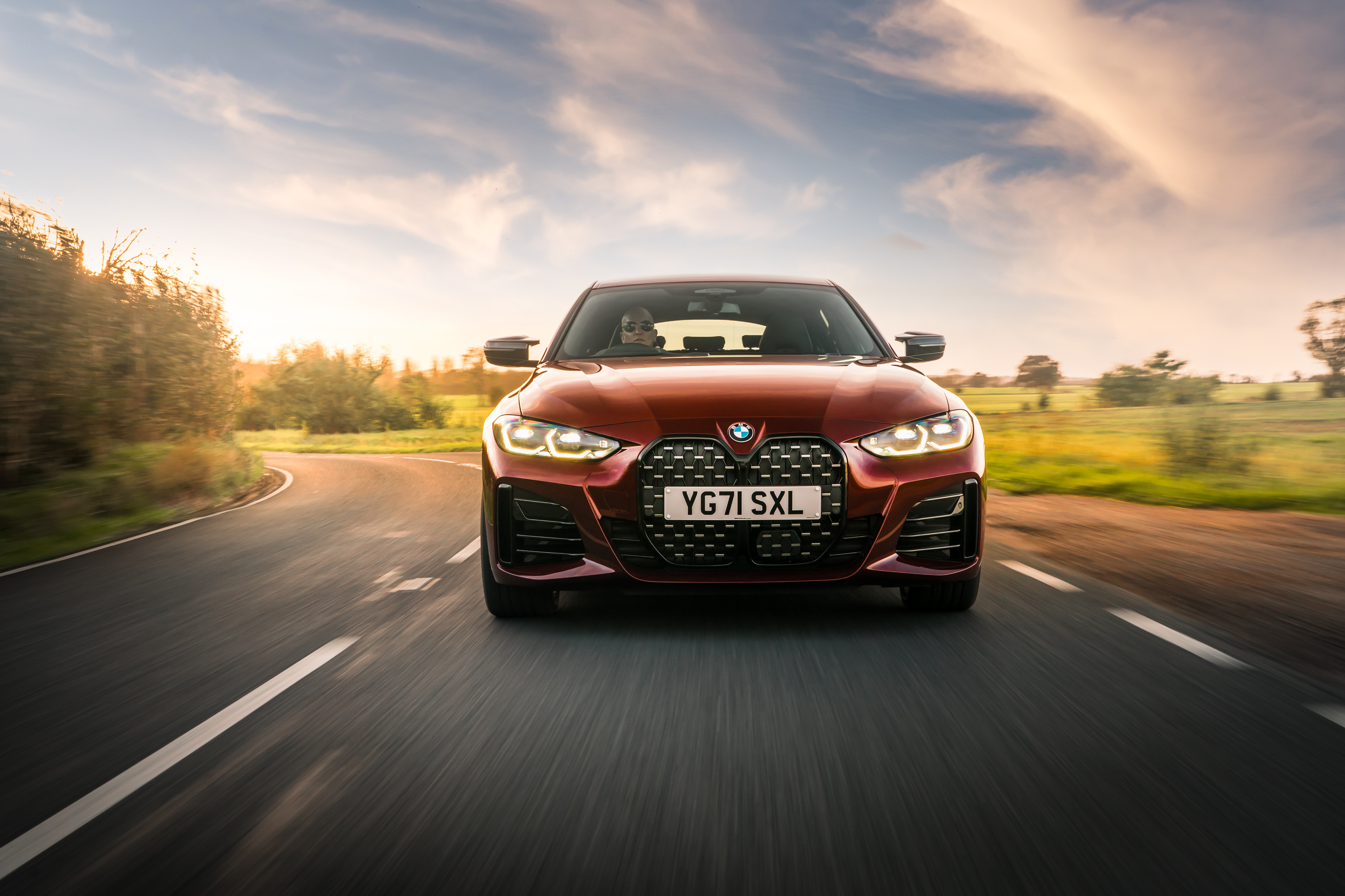 BMW M440i xDrive Gran Coupé on a road HD Wallpaper