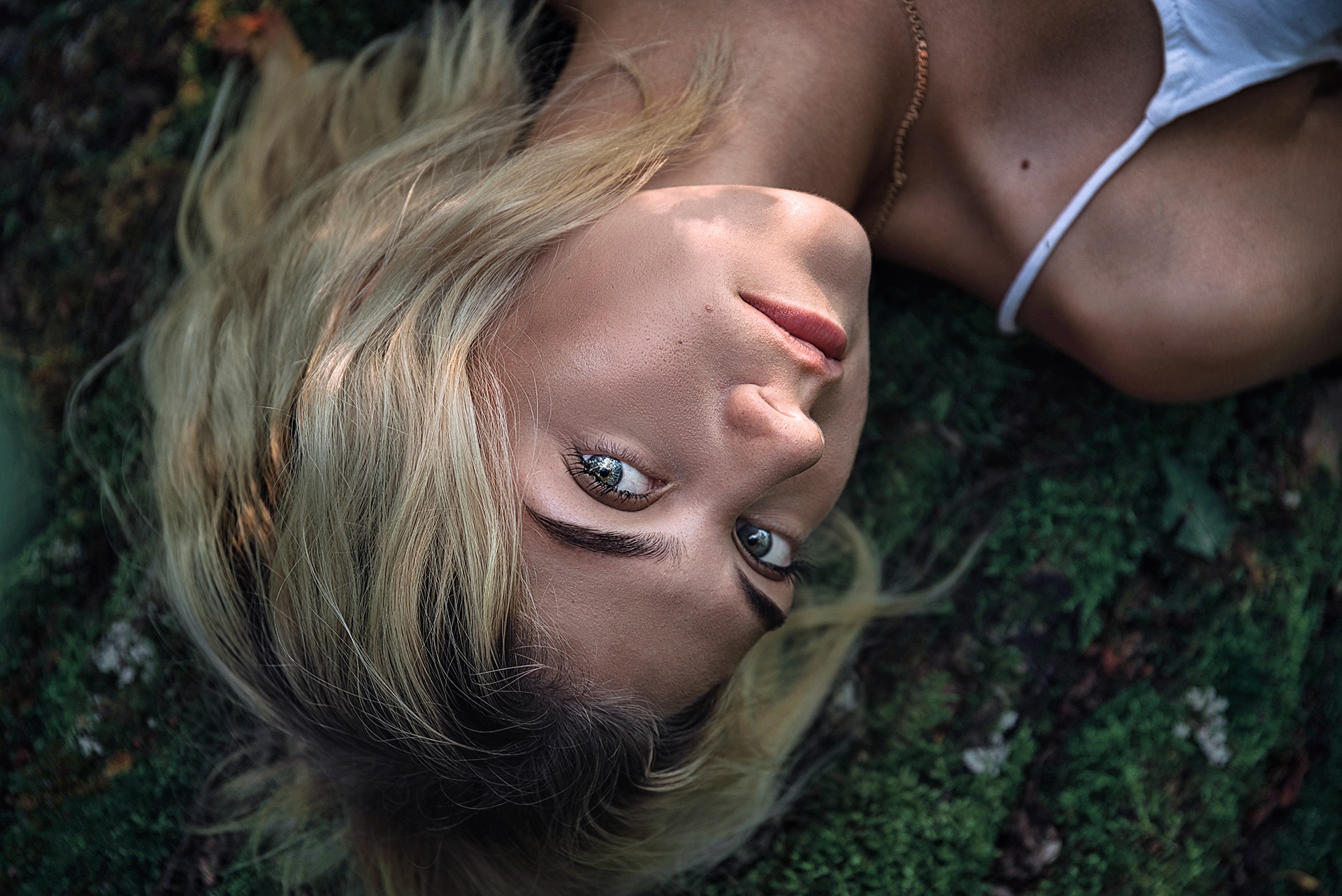 Woman lying on mossy ground HD Wallpaper