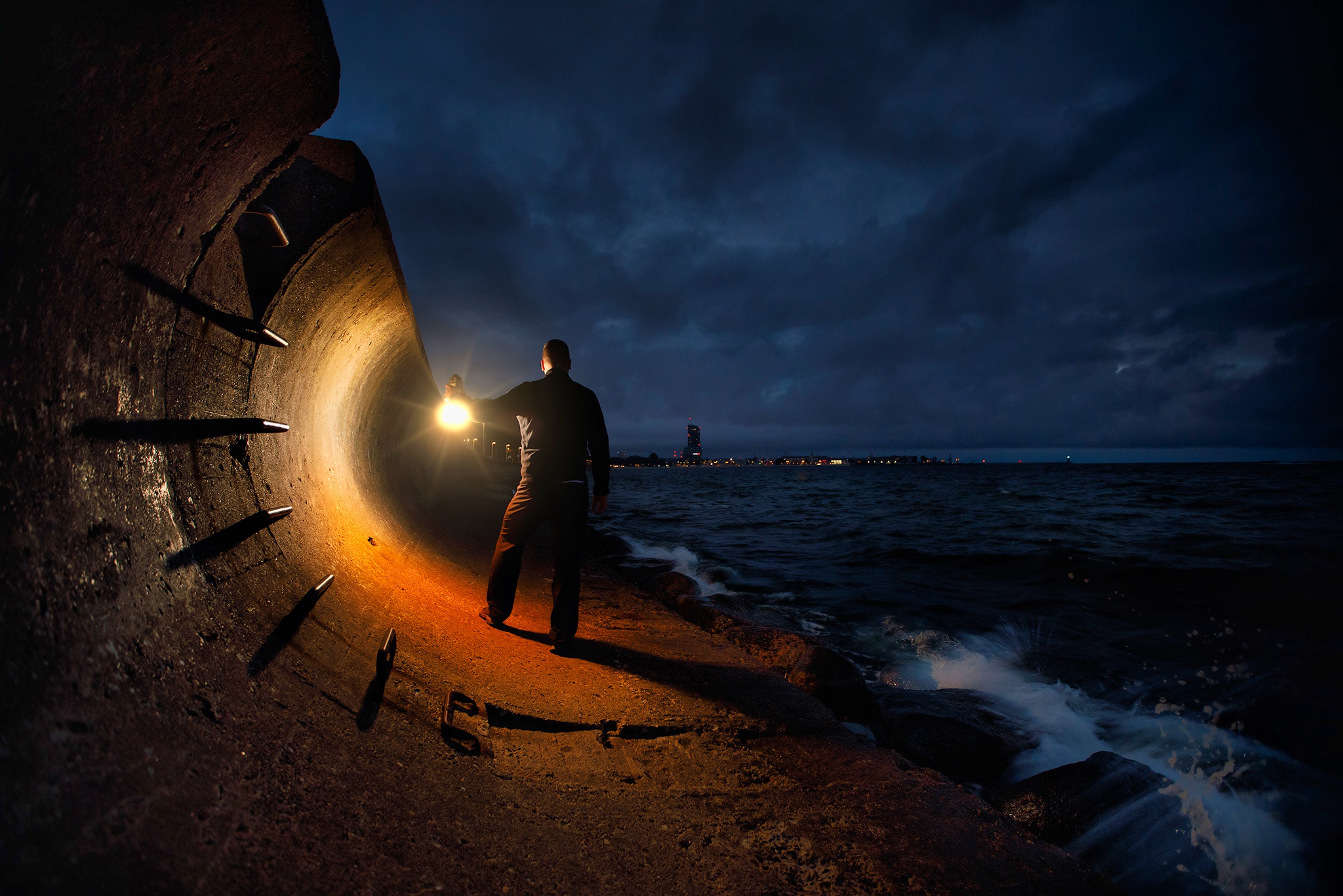 Man with lantern on a pier at night HD Wallpaper