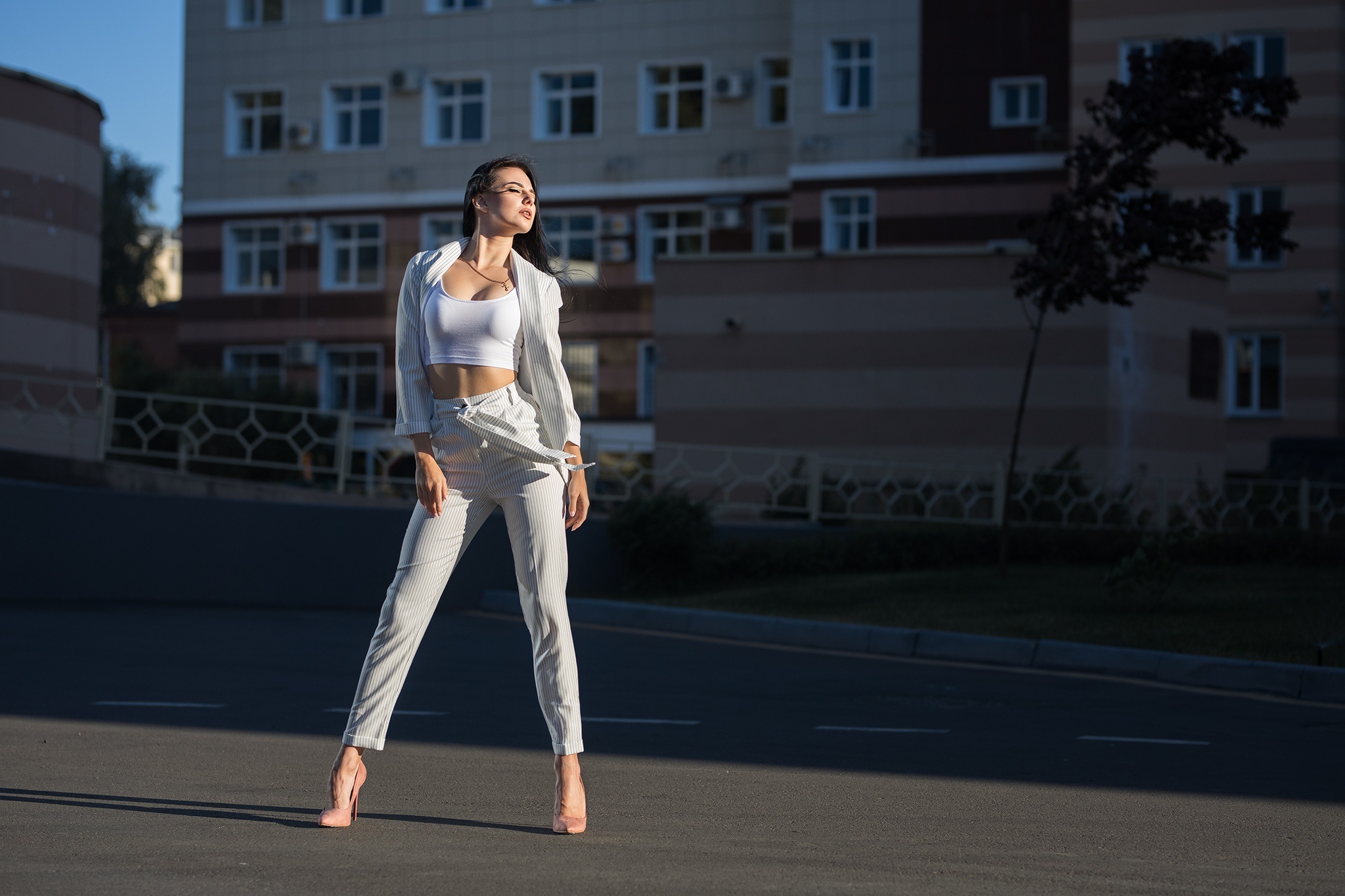 Woman in striped suit posing on street HD Wallpaper