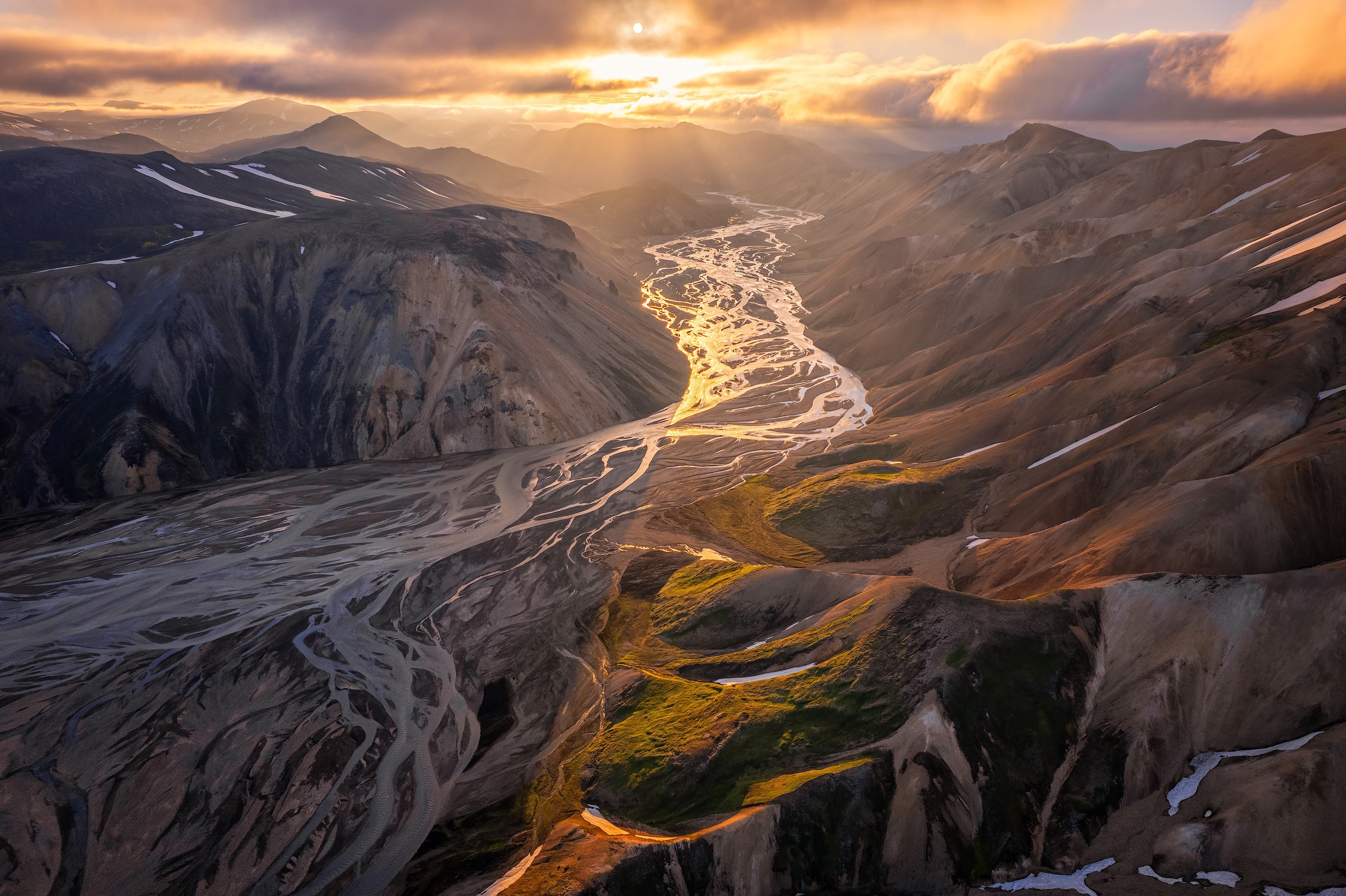 Aerial view of a braided river valley in mountains at sunset HD Wallpaper