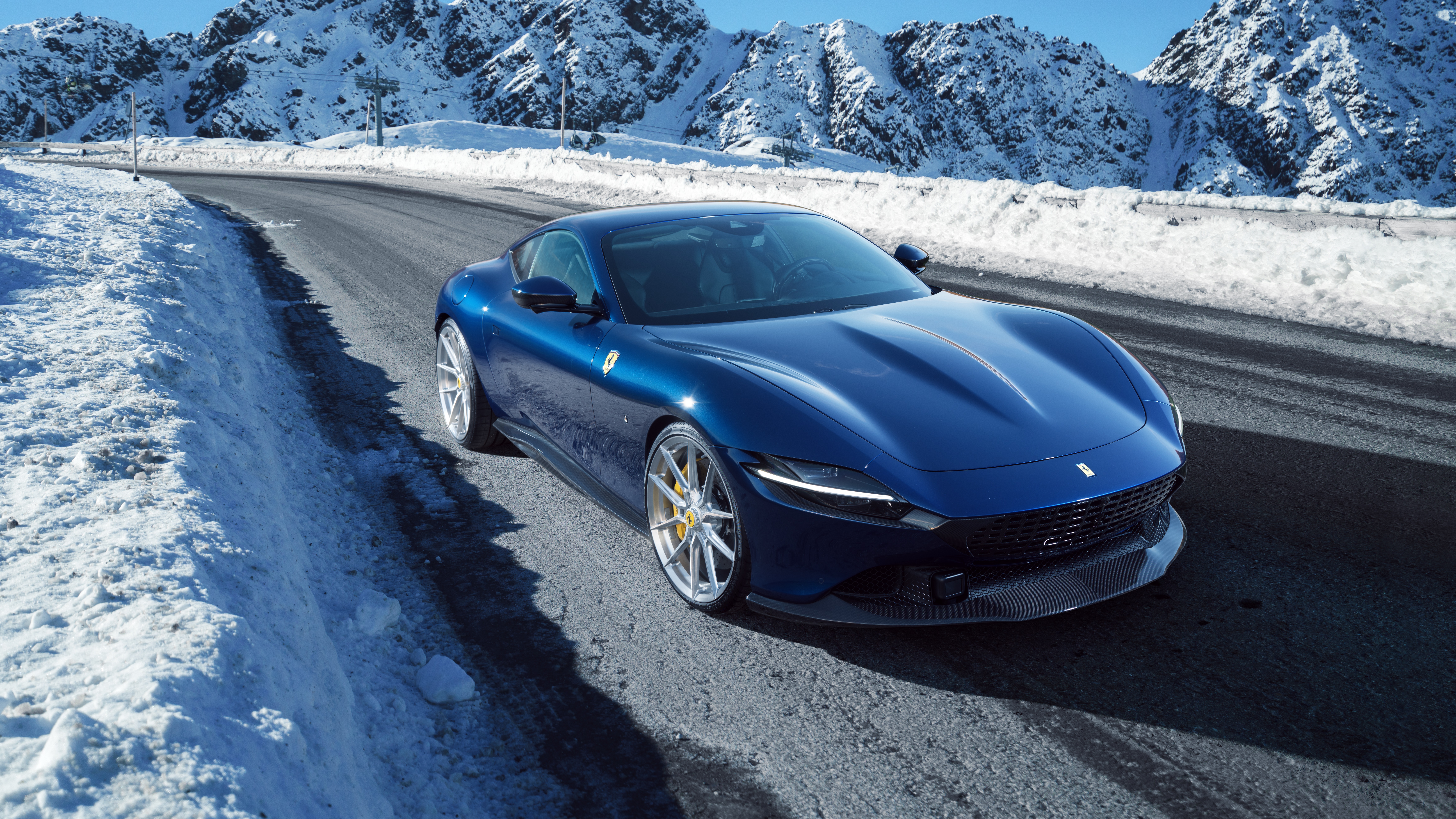 Blue Novitec Ferrari Roma on a snowy mountain road HD Wallpaper