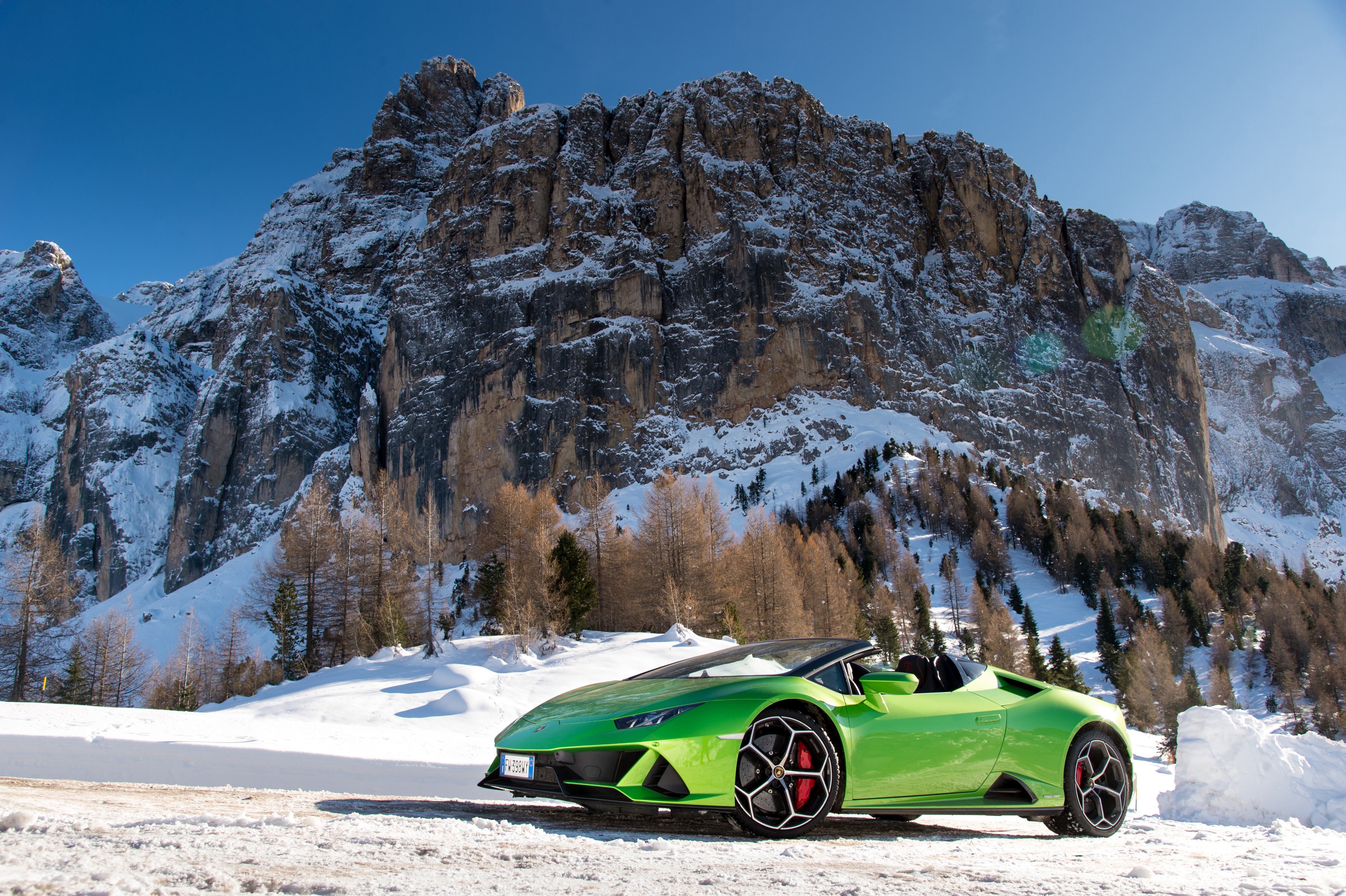 Green Lamborghini Huracan Evo convertible in snowy mountains HD Wallpaper