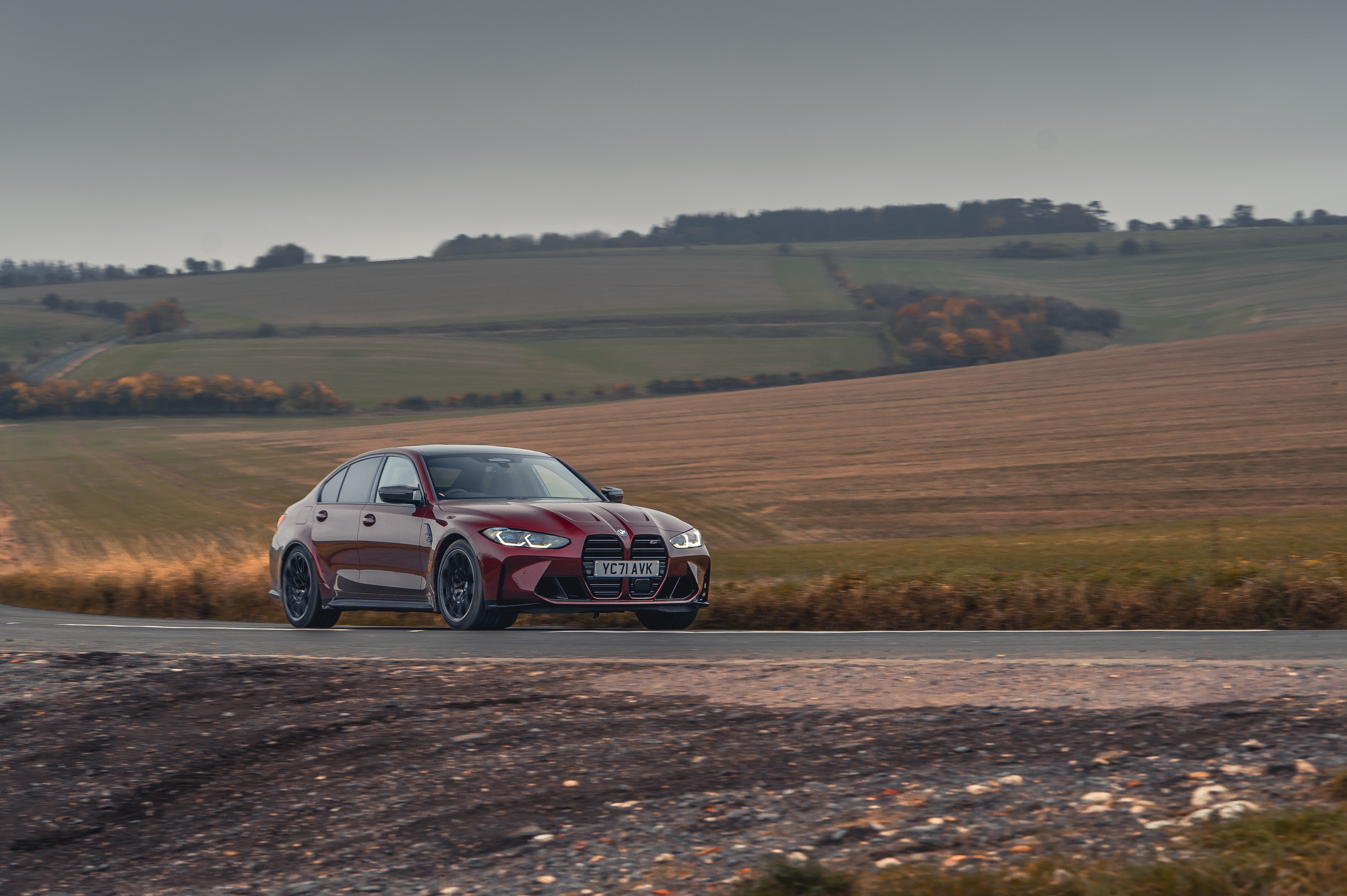 Red BMW M3 Competition M xDrive on a road HD Wallpaper
