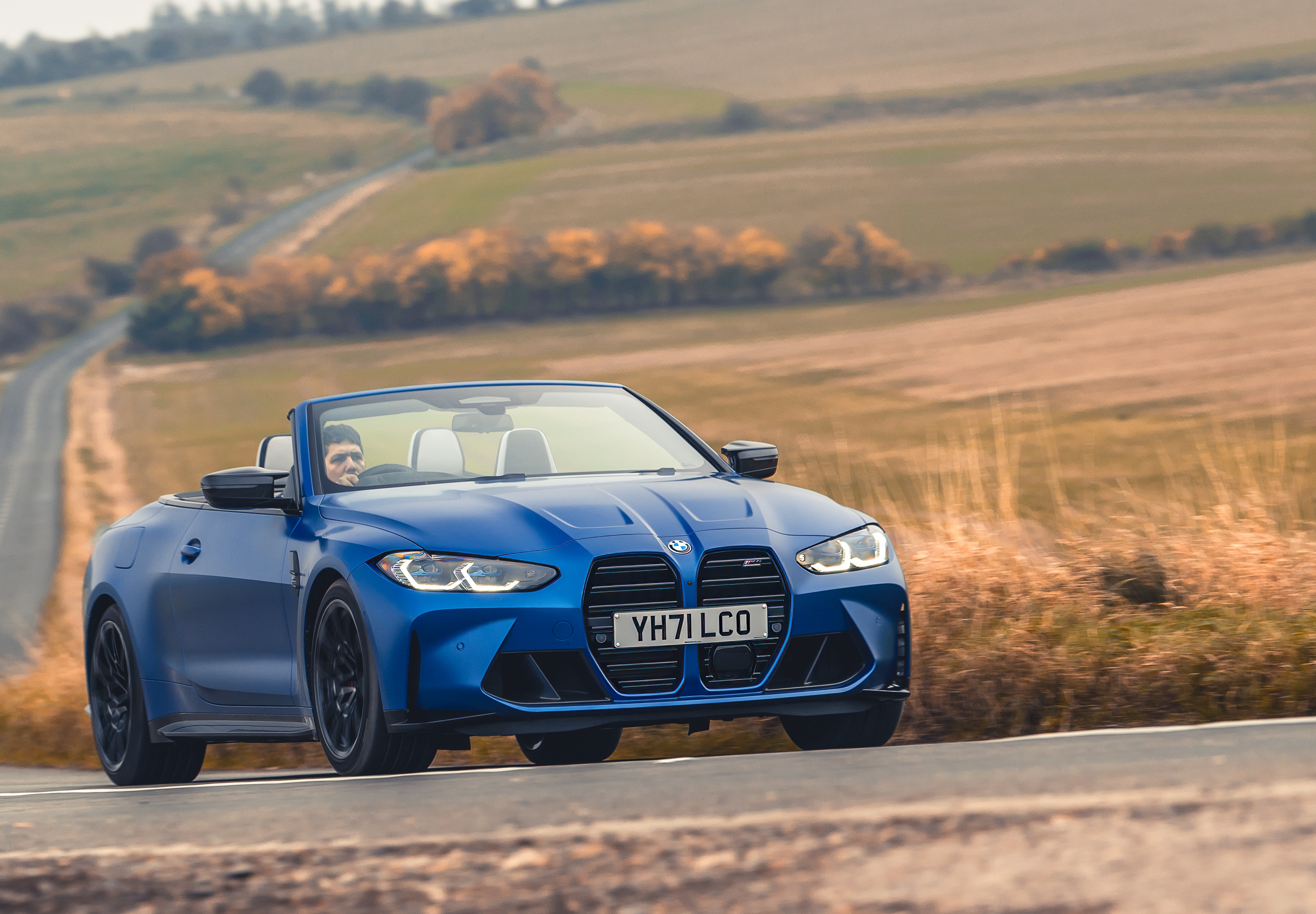 Blue BMW M4 Competition Convertible on a Road HD Wallpaper