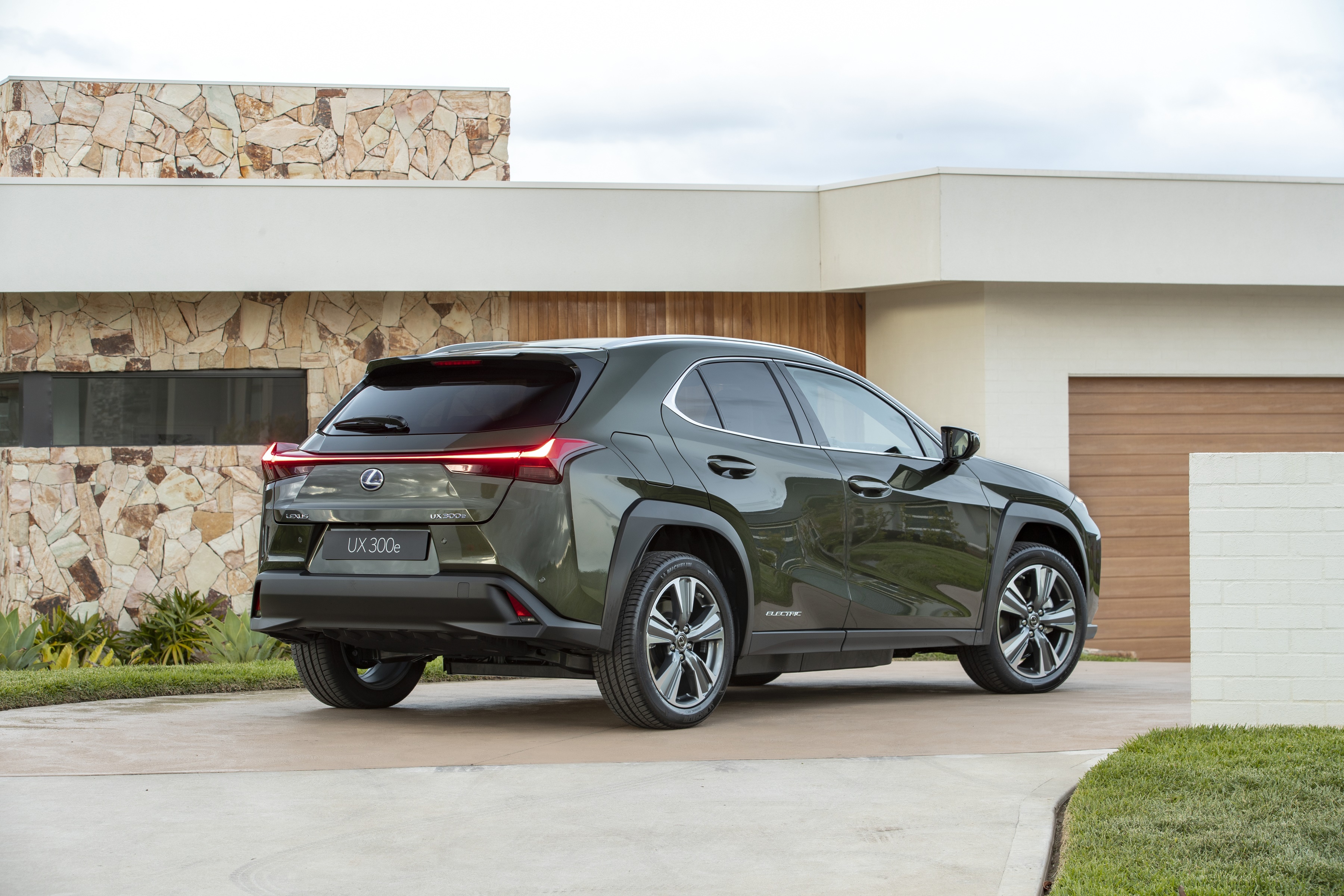 Lexus UX 300e SUV parked near a modern house HD Wallpaper