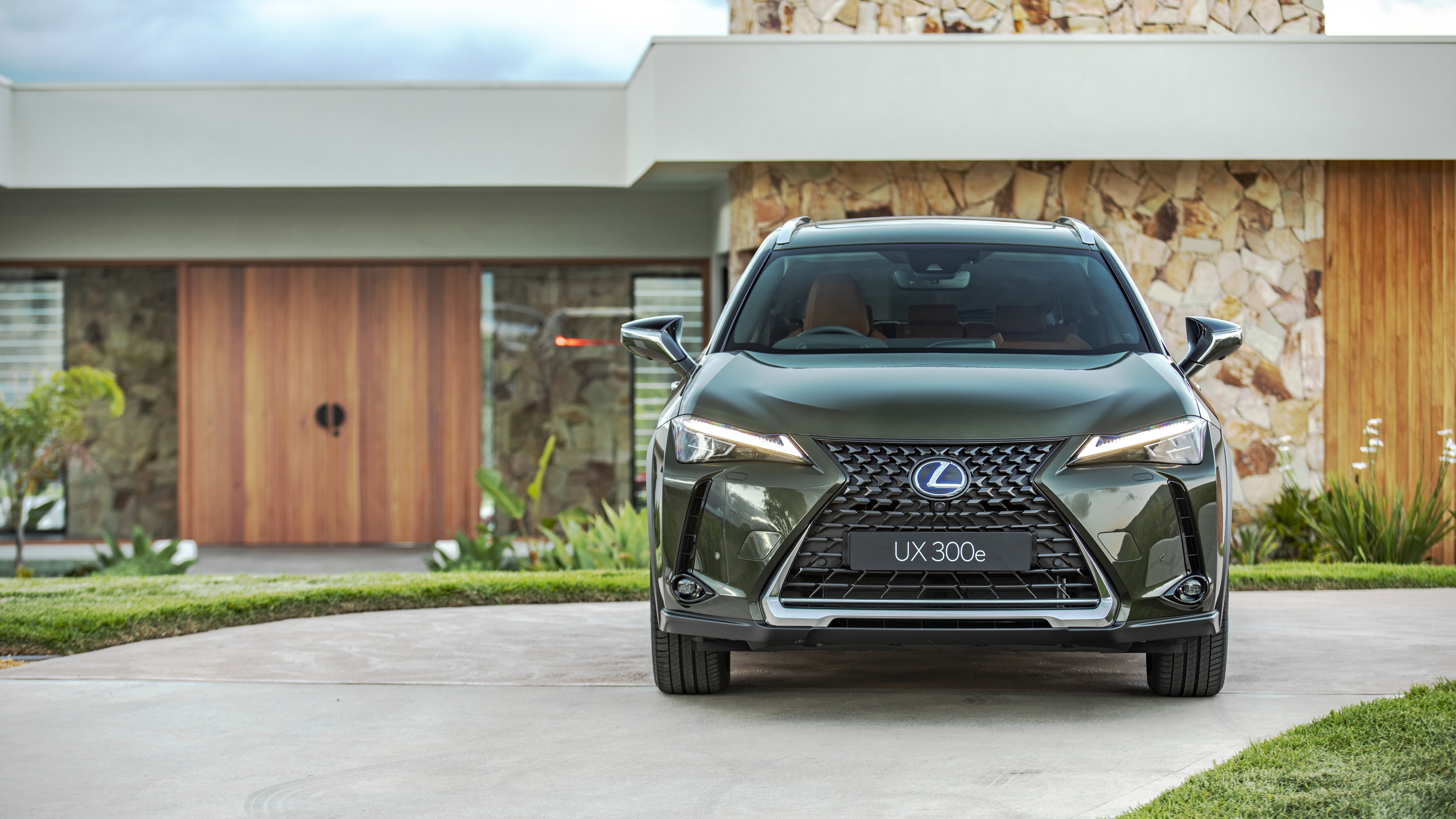 Lexus UX 300e SUV parked in front of modern house HD Wallpaper