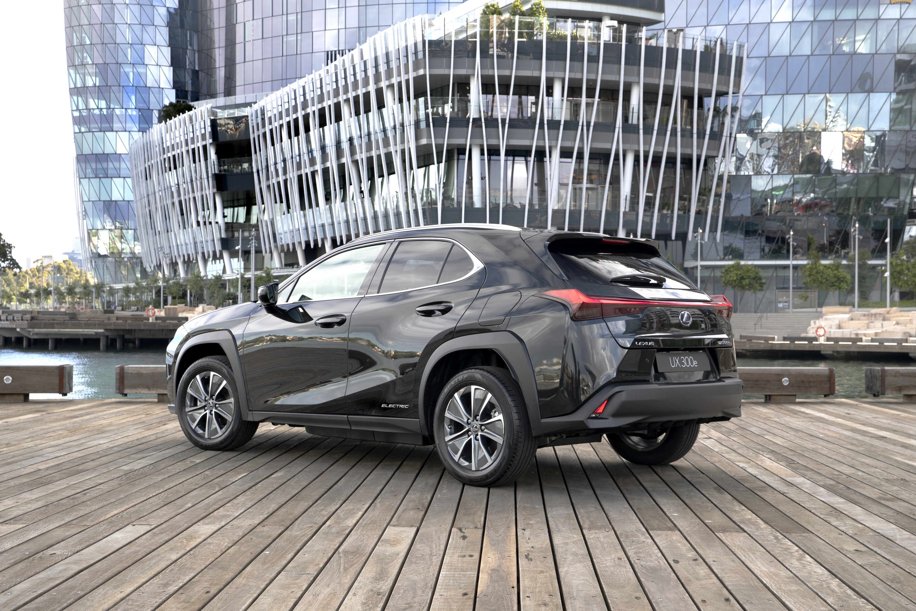 Black Lexus UX 300e parked on a wooden pier HD Wallpaper