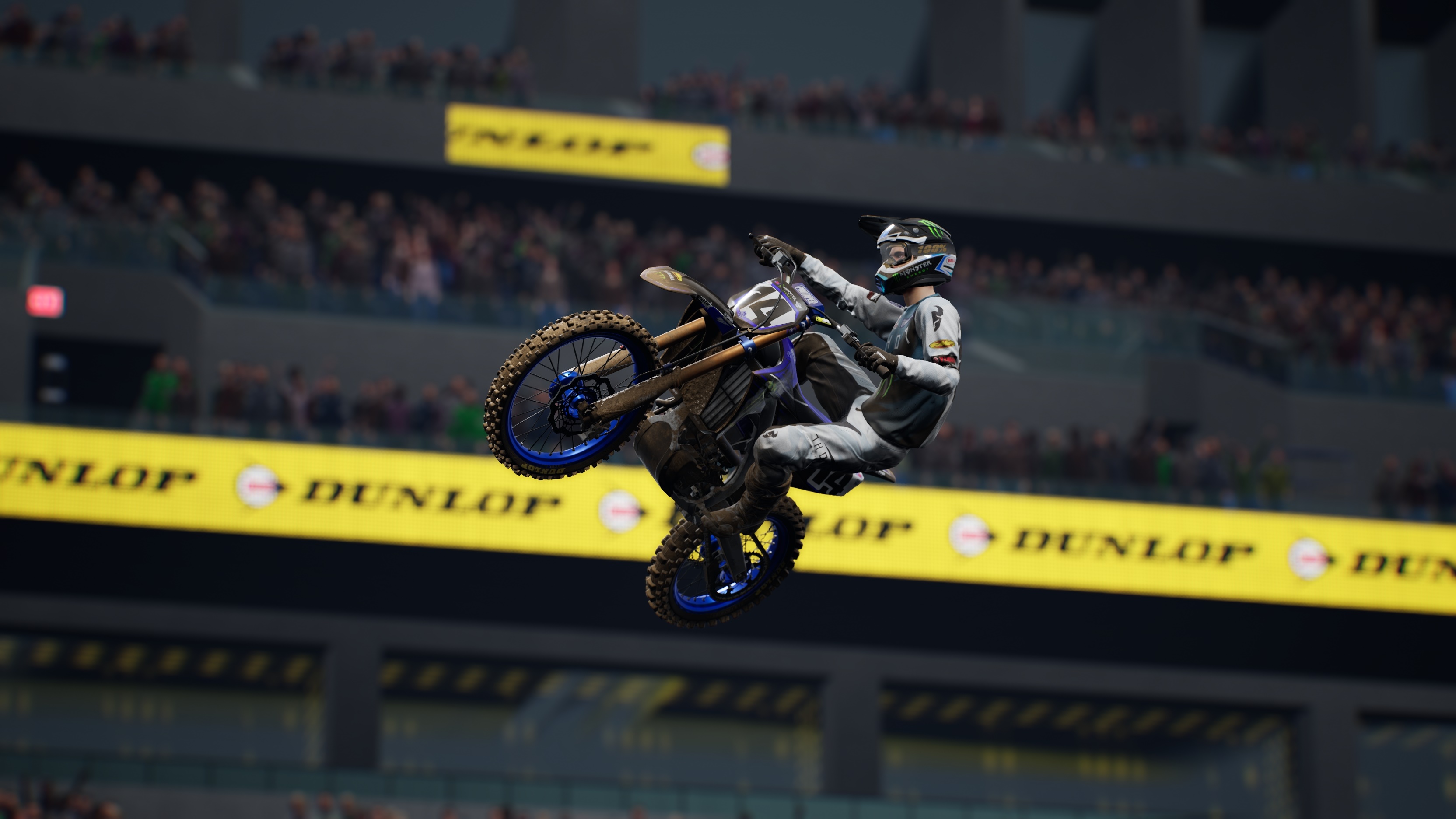 Motocross rider performing a stunt in Monster Energy Supercross 5 HD Wallpaper