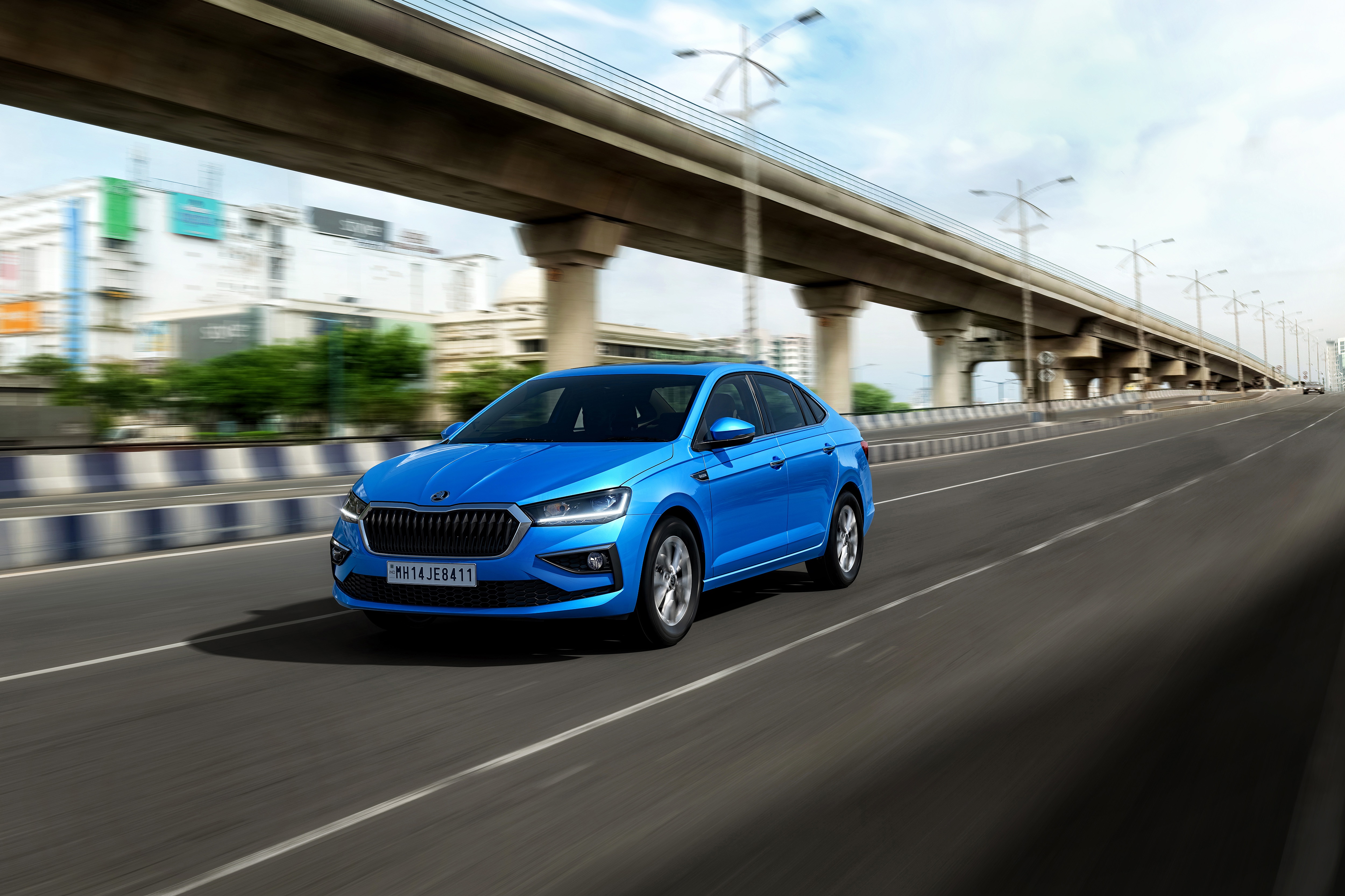 Blue Skoda Slavia driving on a highway HD Wallpaper