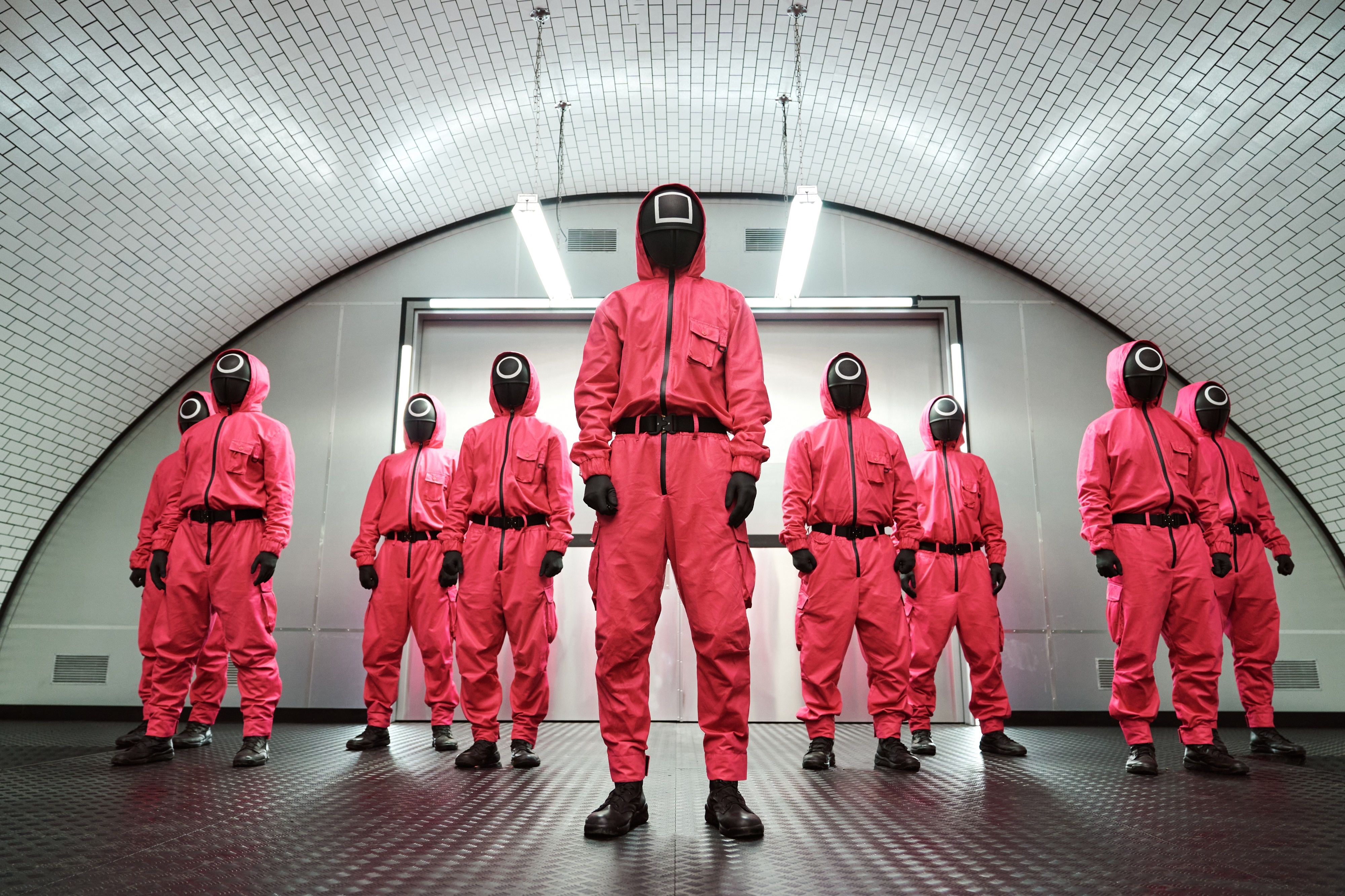 Squid Game guards in pink jumpsuits HD Wallpaper