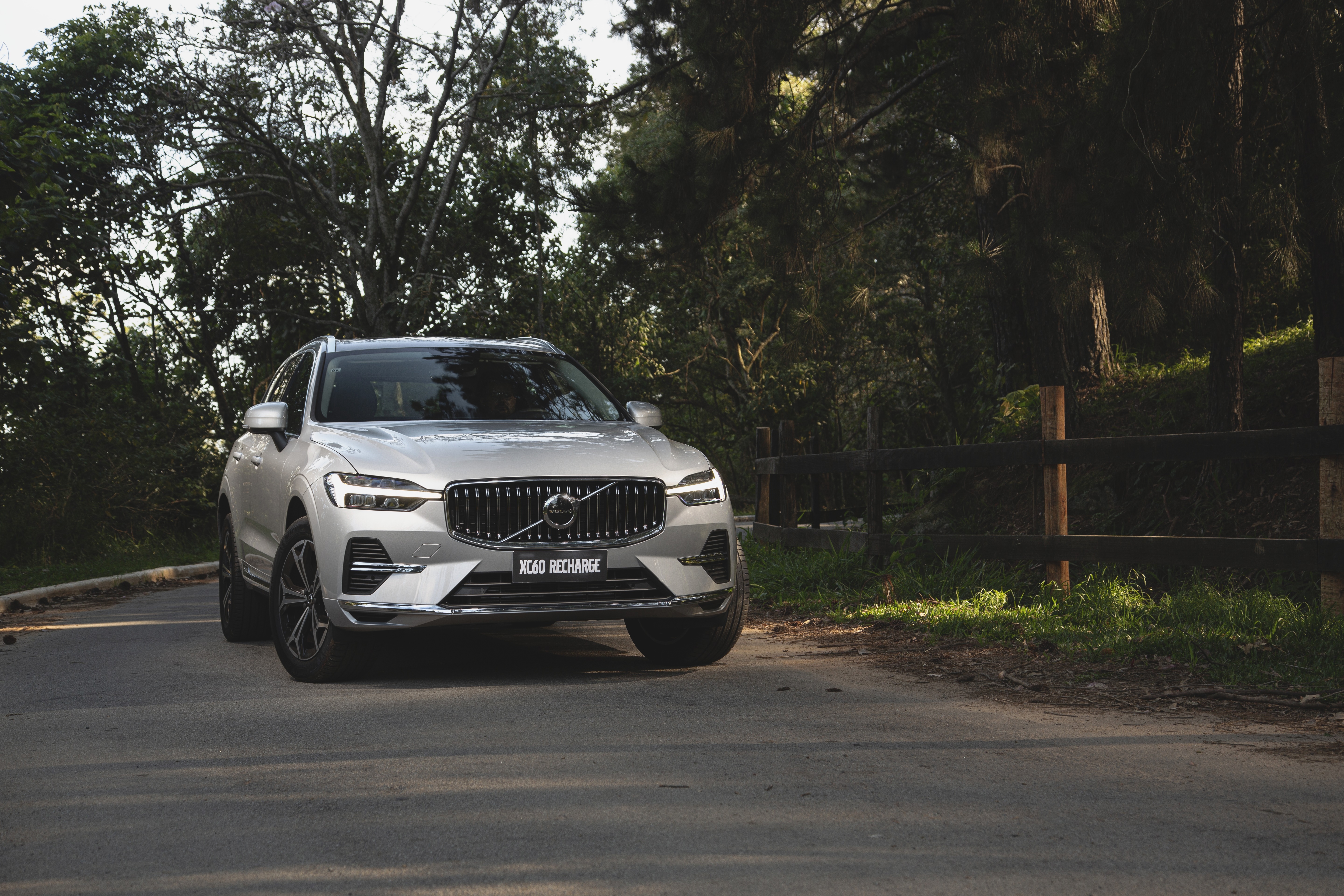 Silver Volvo XC60 Recharge SUV on a road HD Wallpaper