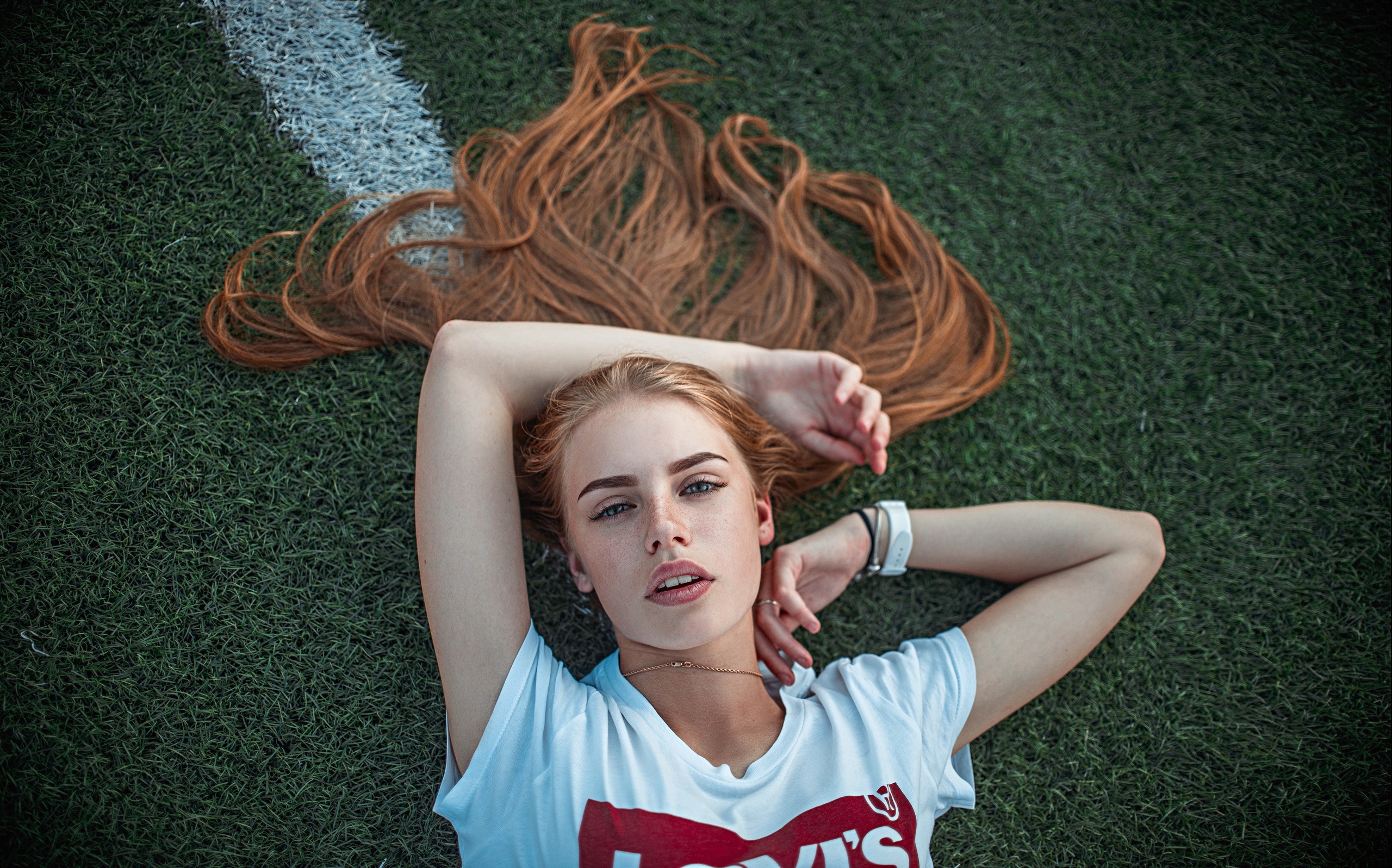 Redhead lying on grass HD Wallpaper