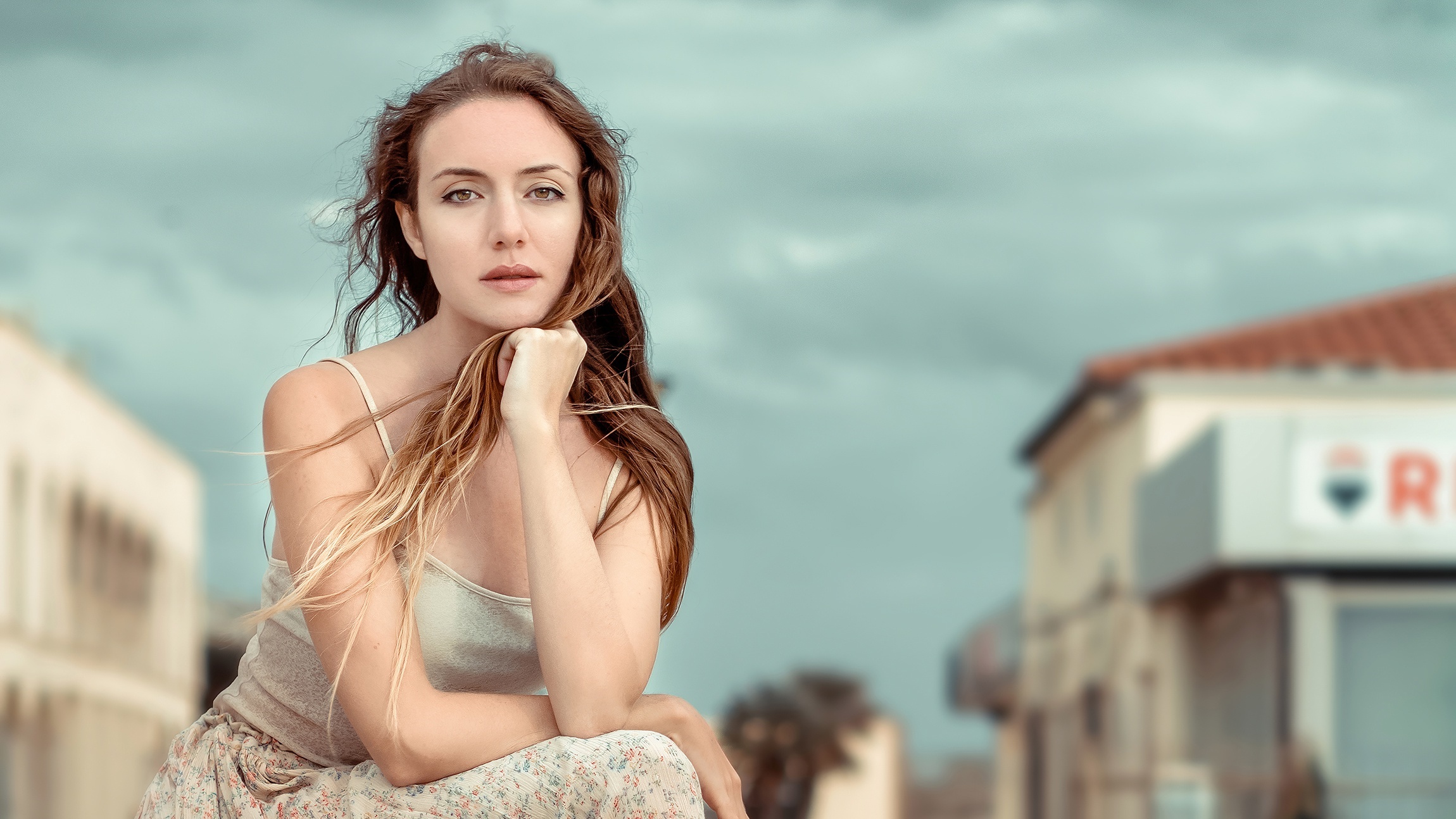 Woman with long brown hair in a light-colored top and floral skirt HD Wallpaper