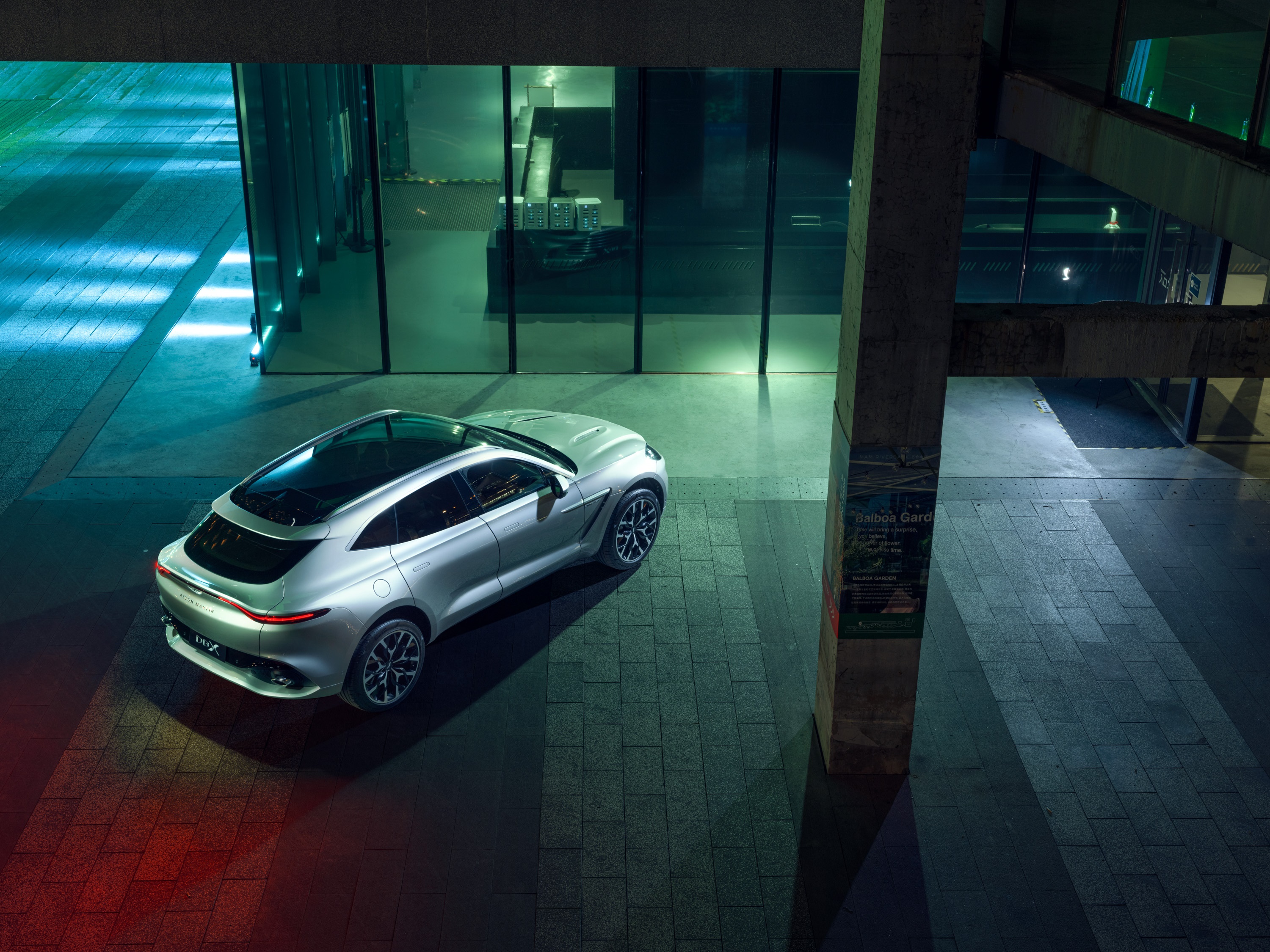 Aston Martin DBX SUV parked at night HD Wallpaper