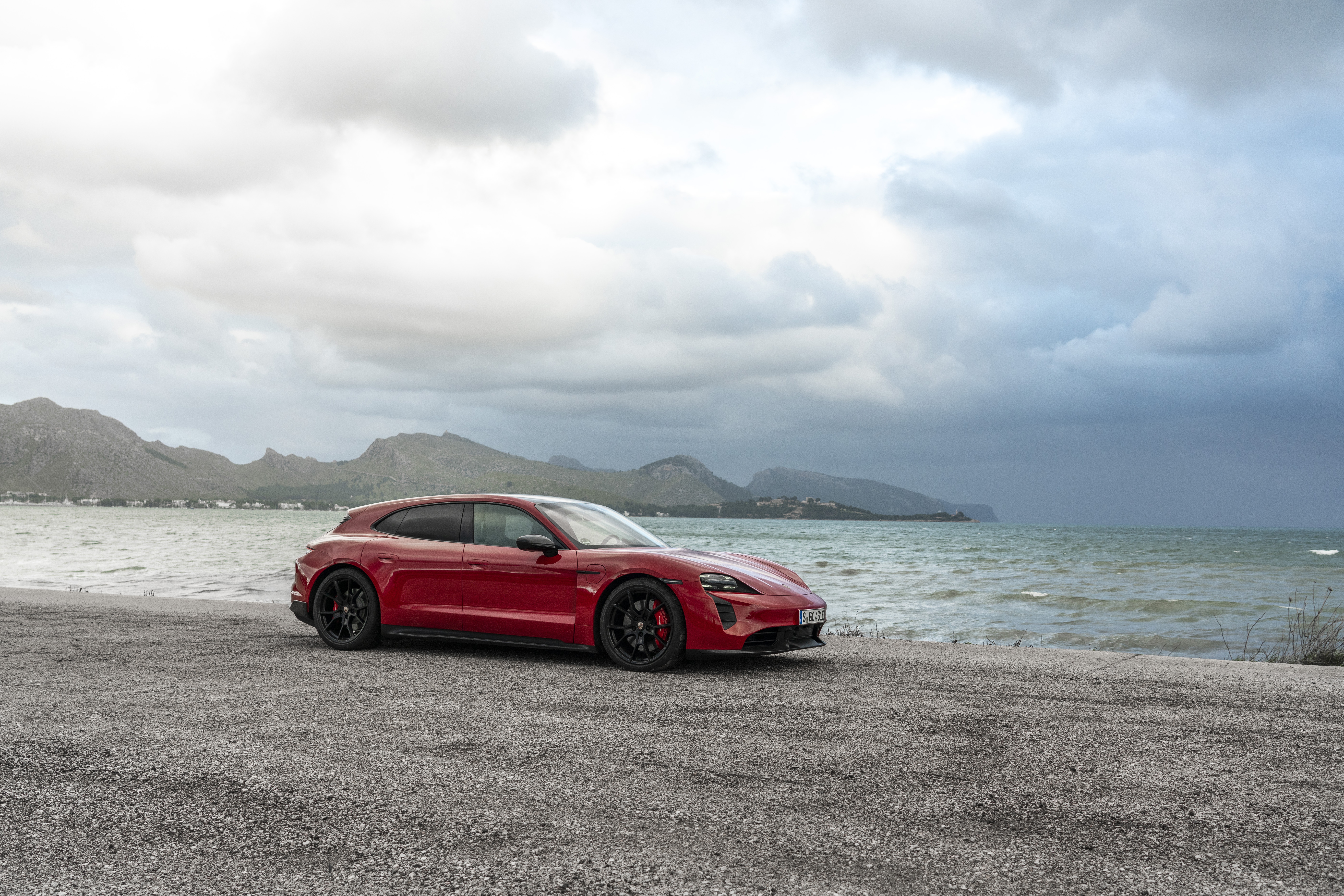 Red Porsche Taycan GTS Sport Turismo by the sea HD Wallpaper