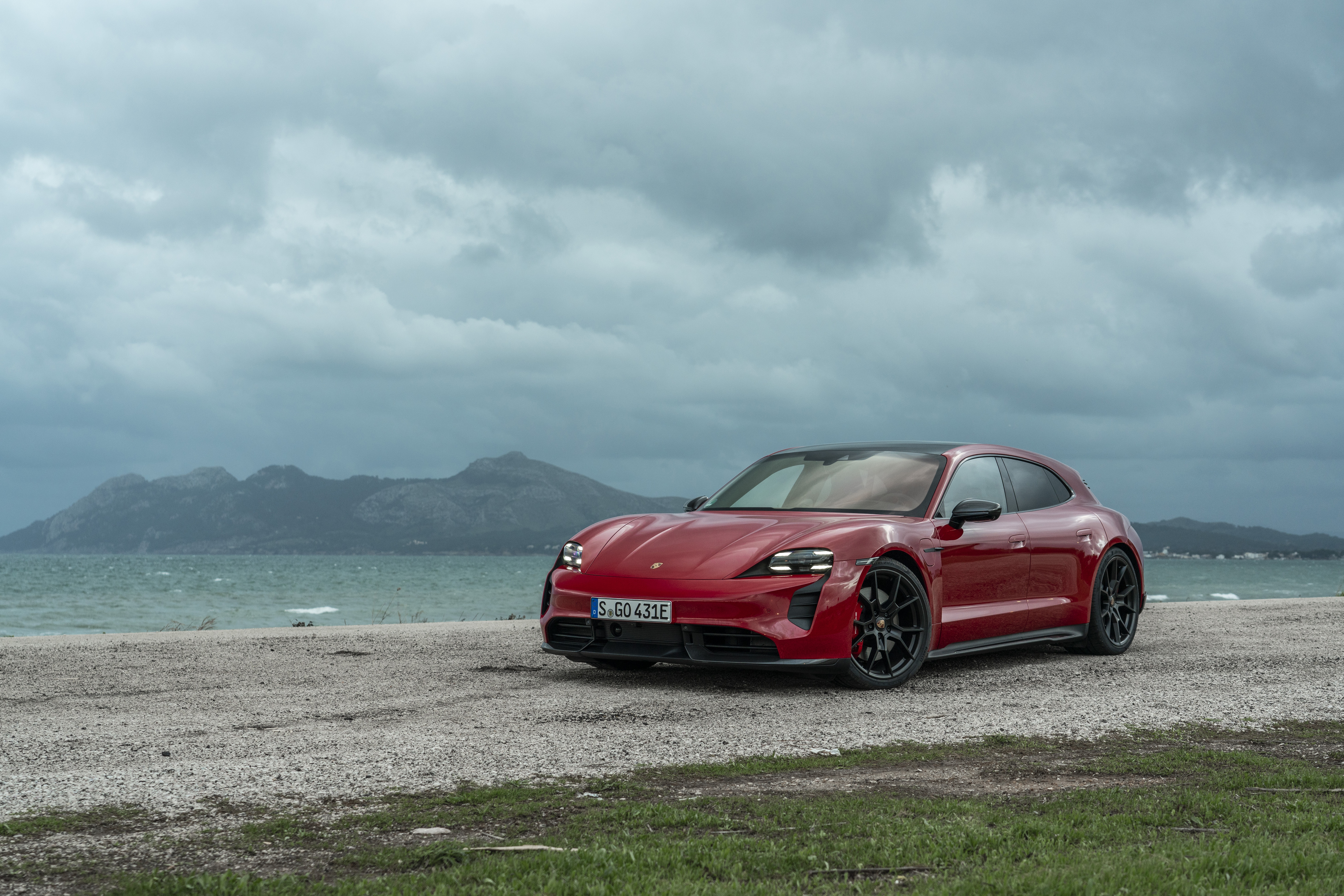 Red Porsche Taycan GTS Sport Turismo by the sea HD Wallpaper
