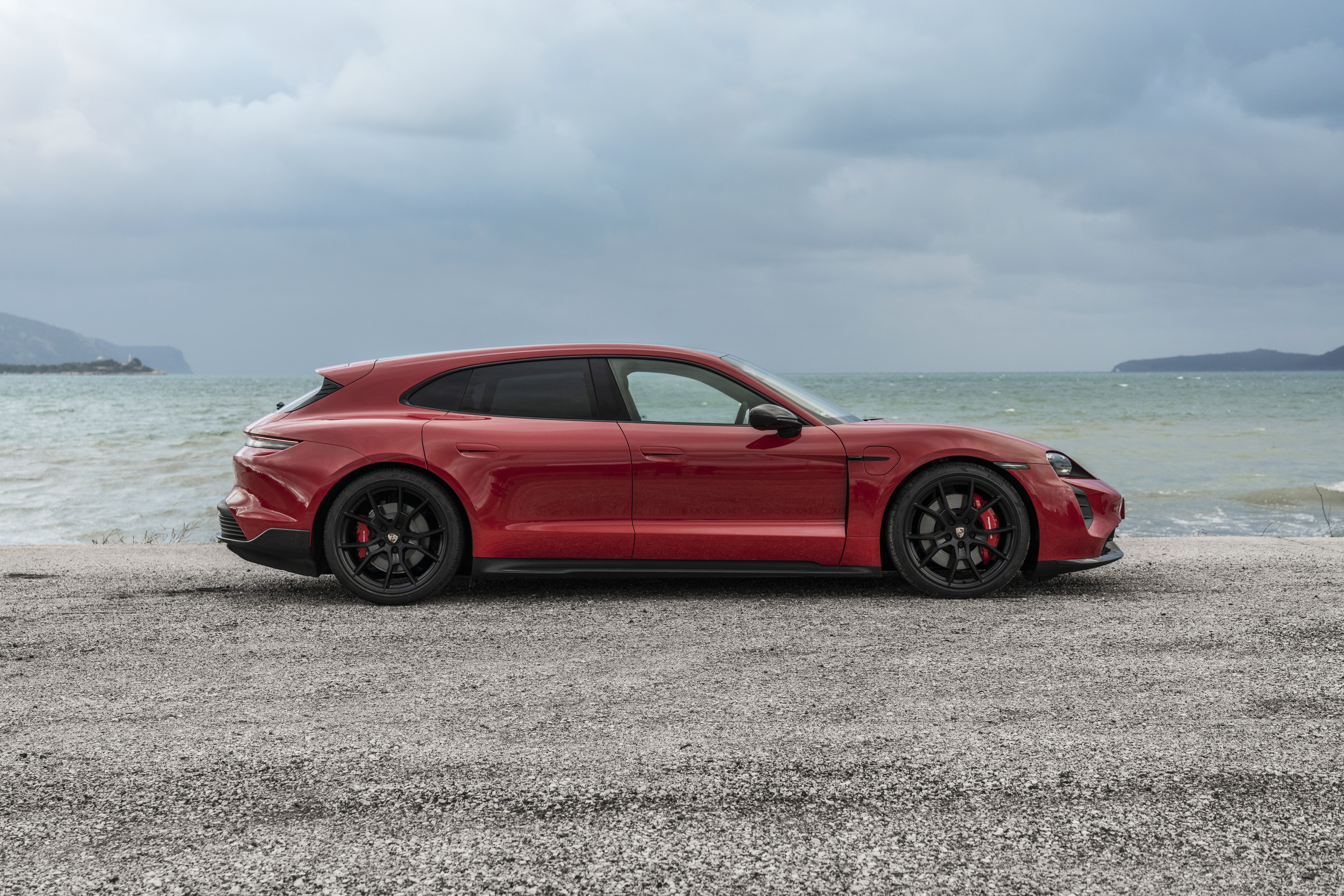 Red Porsche Taycan GTS Sport Turismo by the sea HD Wallpaper