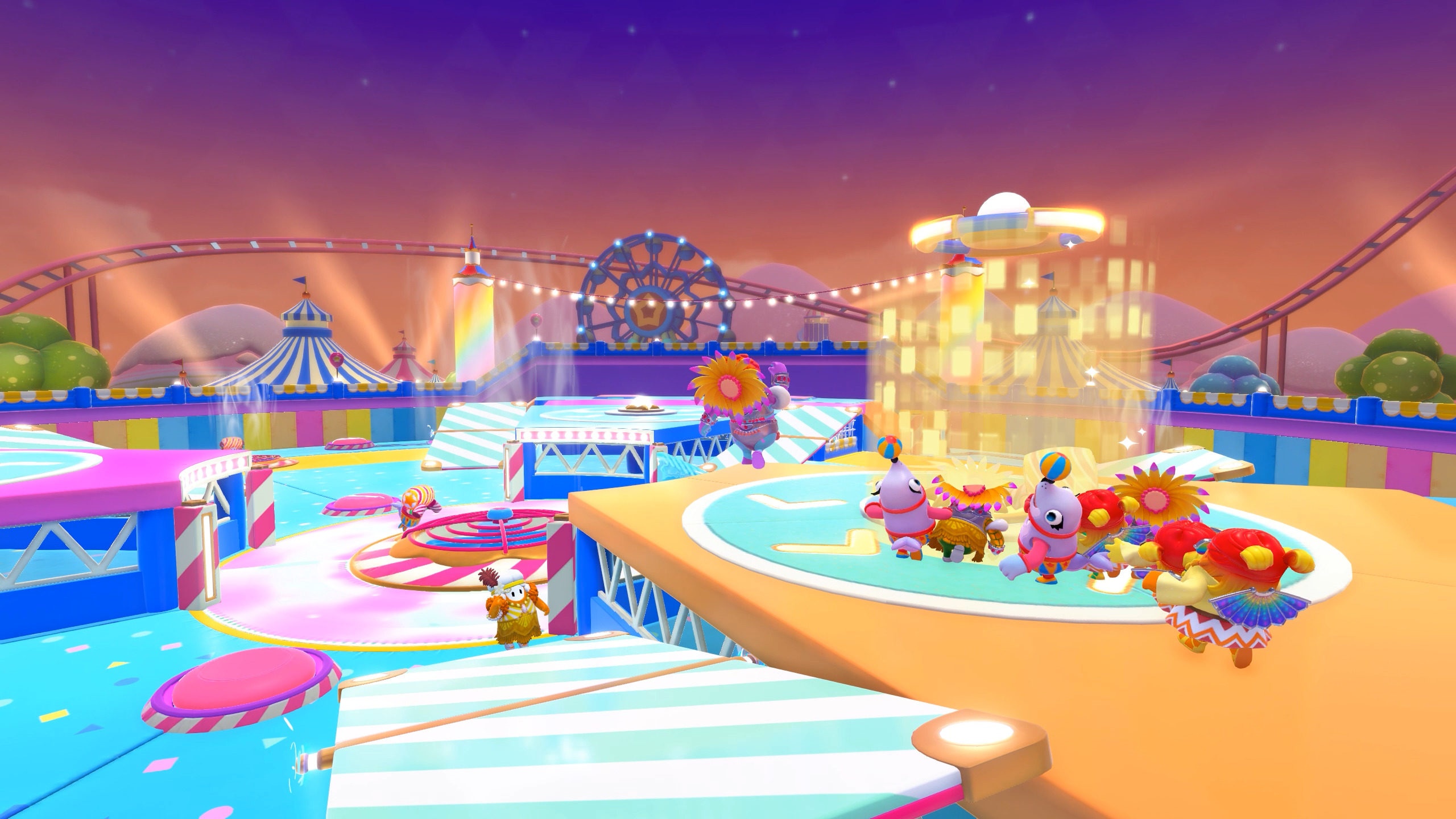 Fall Guys characters in a colorful carnival setting HD Wallpaper
