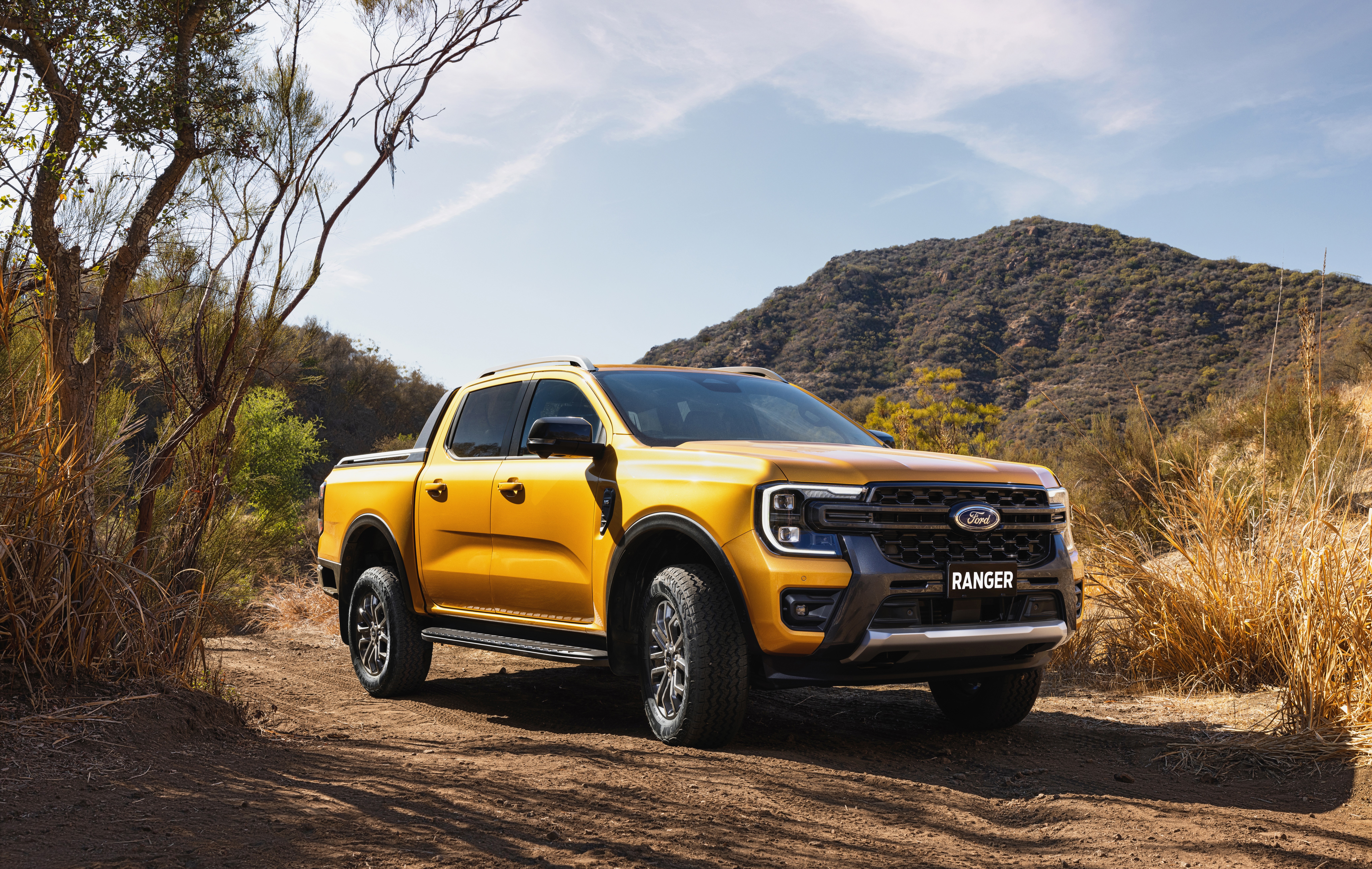 Yellow Ford Ranger Wildtrak on a dirt road HD Wallpaper