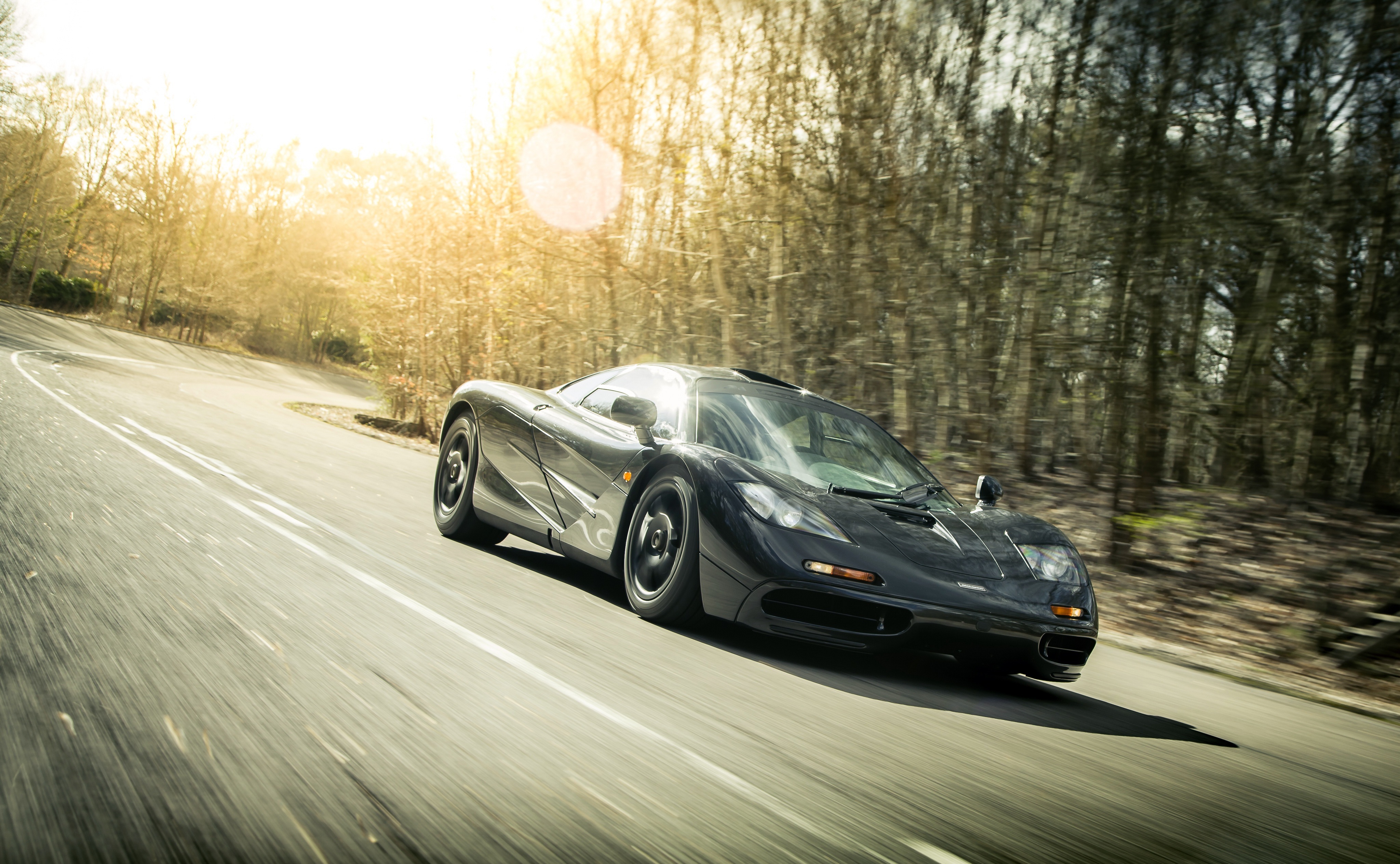 Black McLaren F1 Supercar on a Winding Road HD Wallpaper