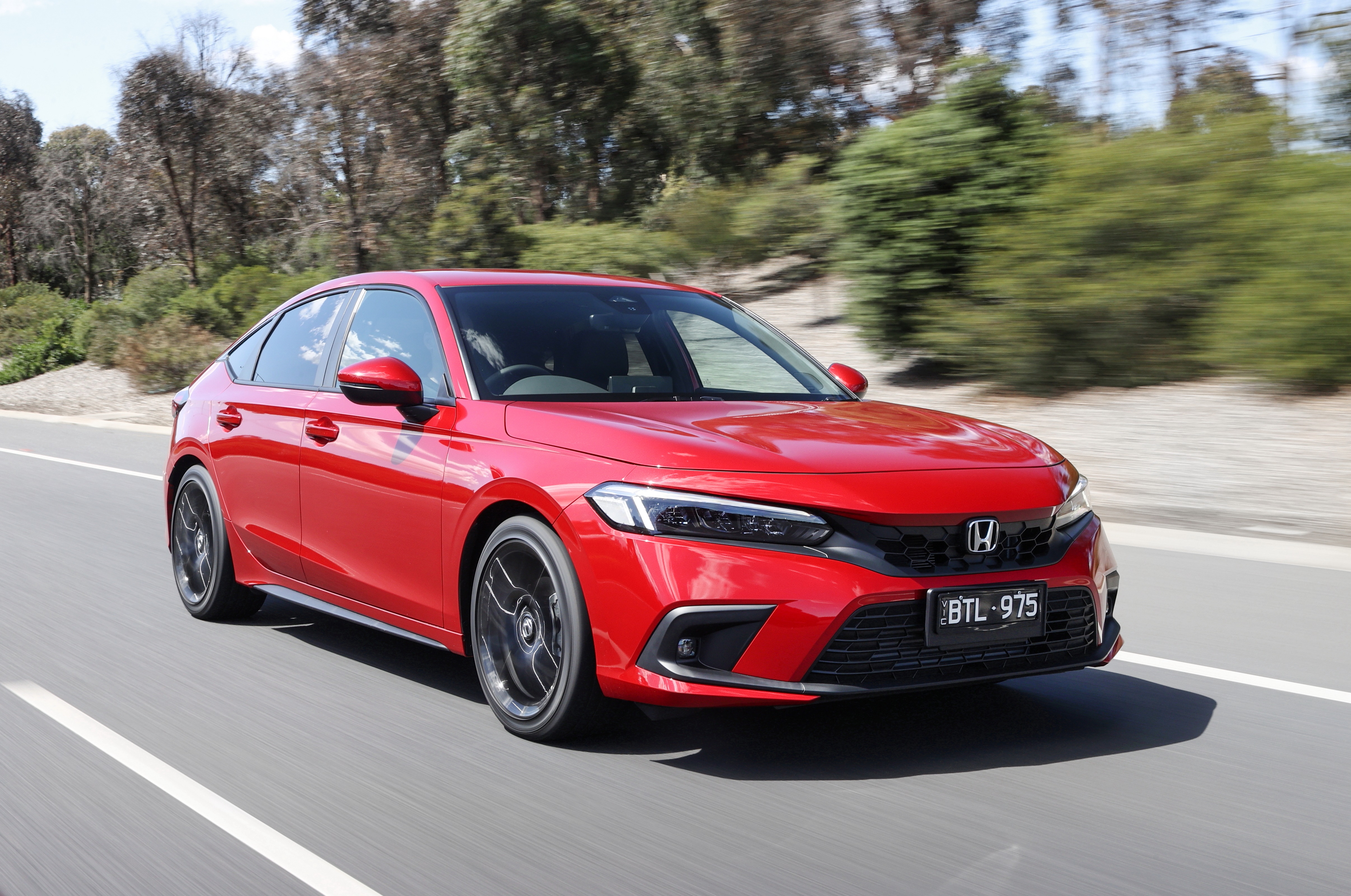 Red Honda Civic Hatchback driving on a road HD Wallpaper