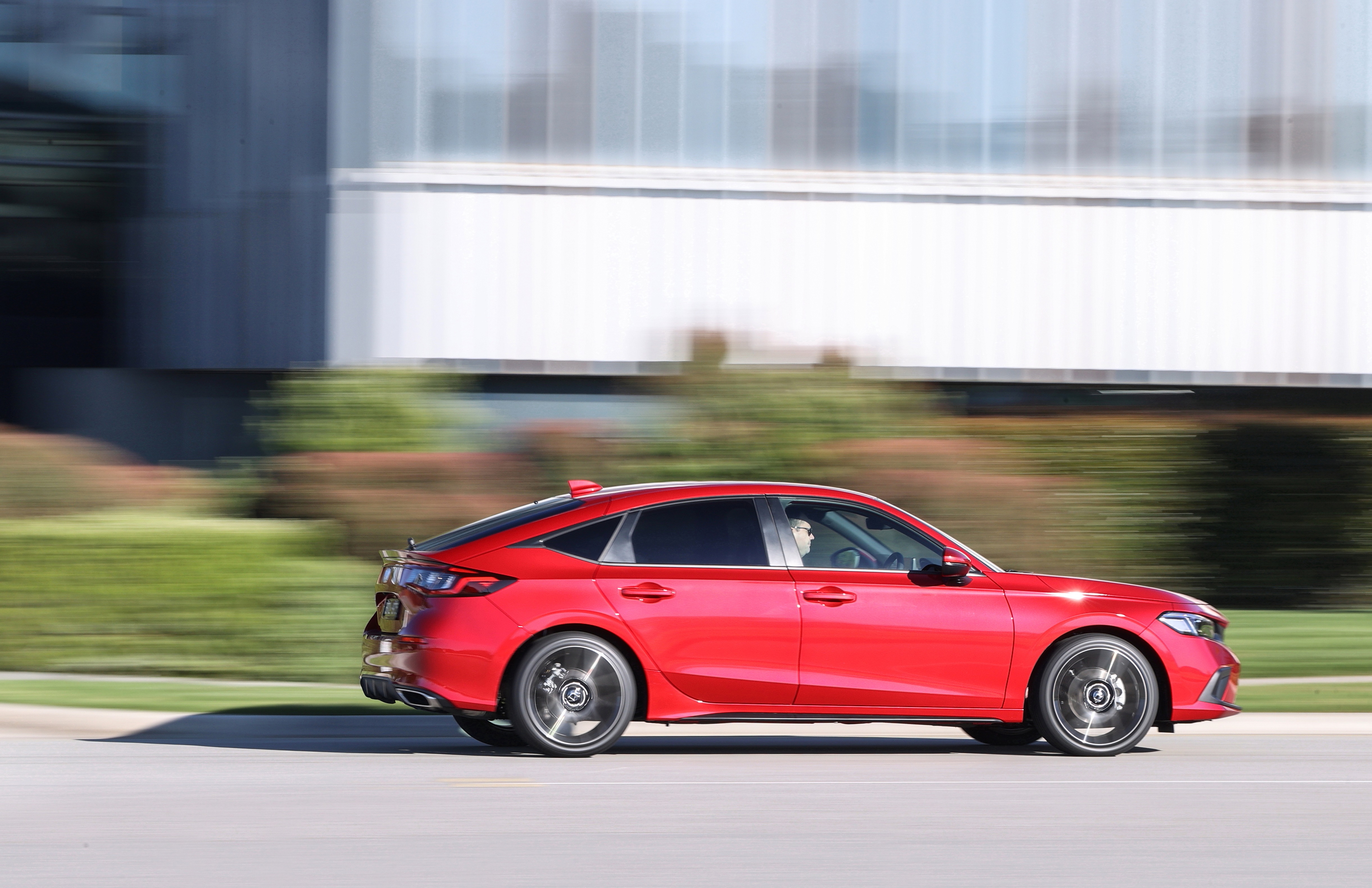 Red Honda Civic Hatchback driving on a road HD Wallpaper