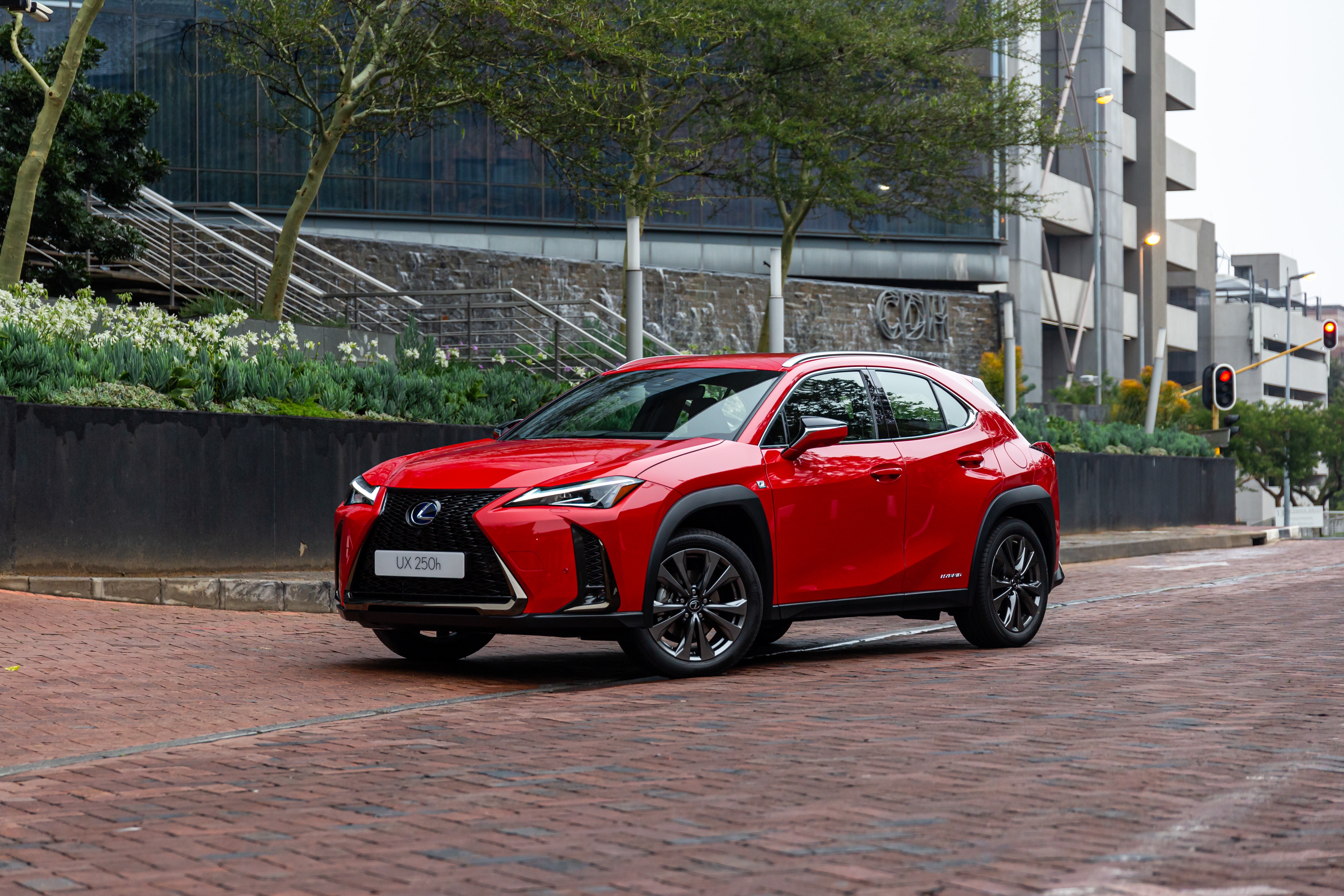 Red Lexus UX 250h F SPORT parked on brick road HD Wallpaper