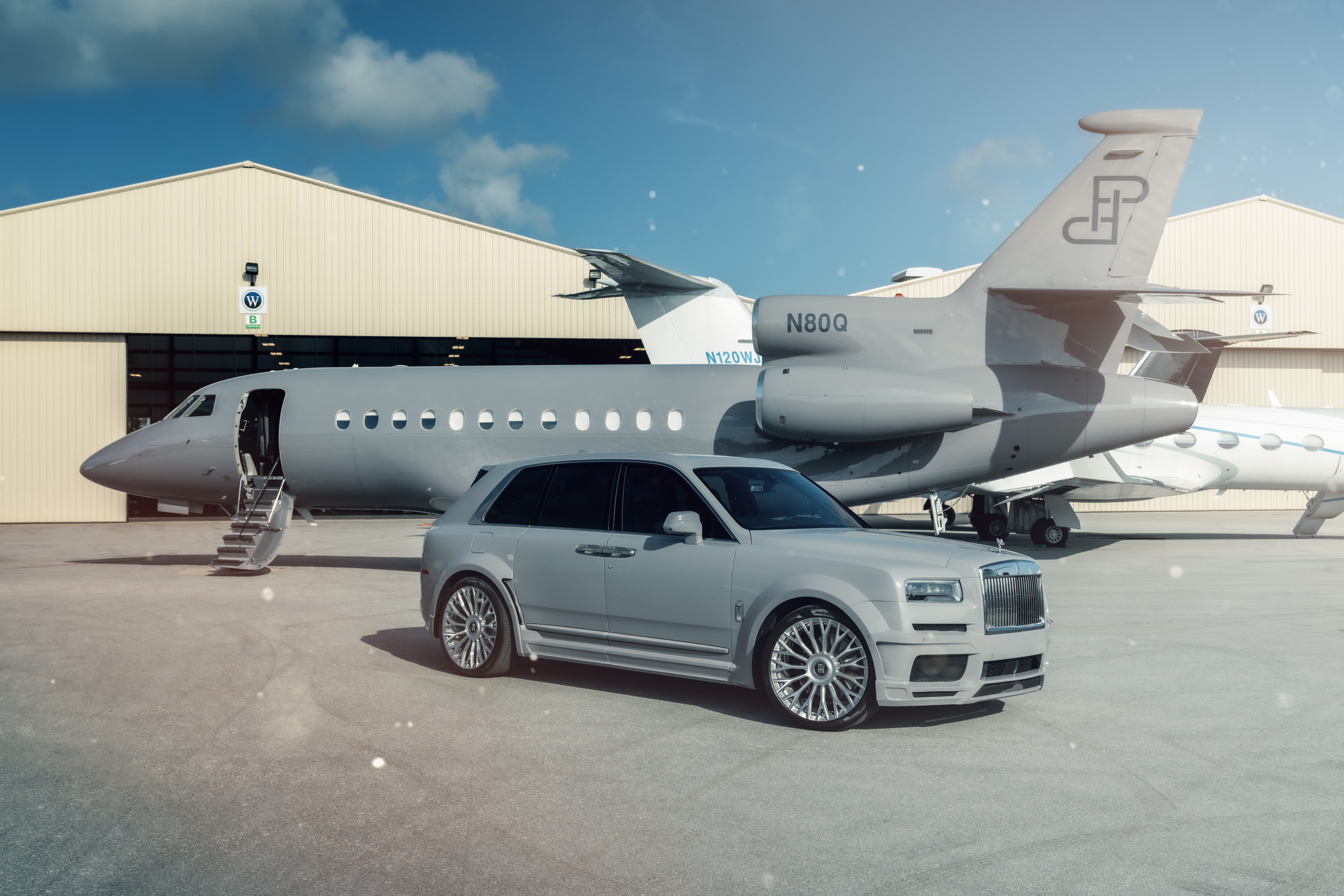 Rolls-Royce Cullinan and Falcon 900EX aircraft HD Wallpaper