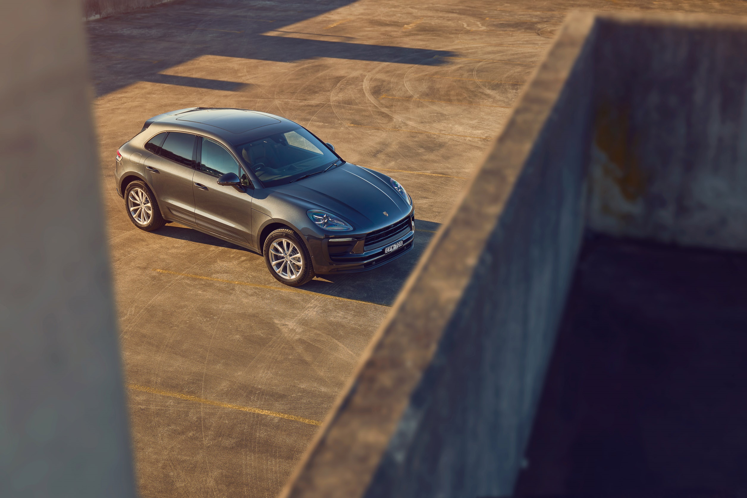 Porsche Macan SUV parked on concrete HD Wallpaper