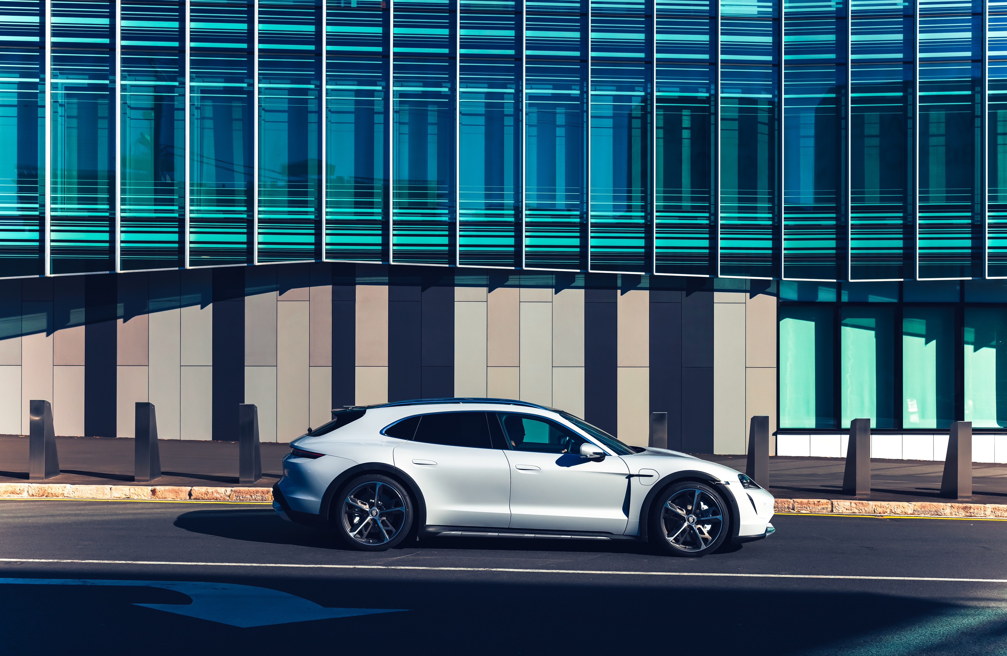Porsche Taycan Turbo Cross Turismo parked in front of a modern building HD Wallpaper