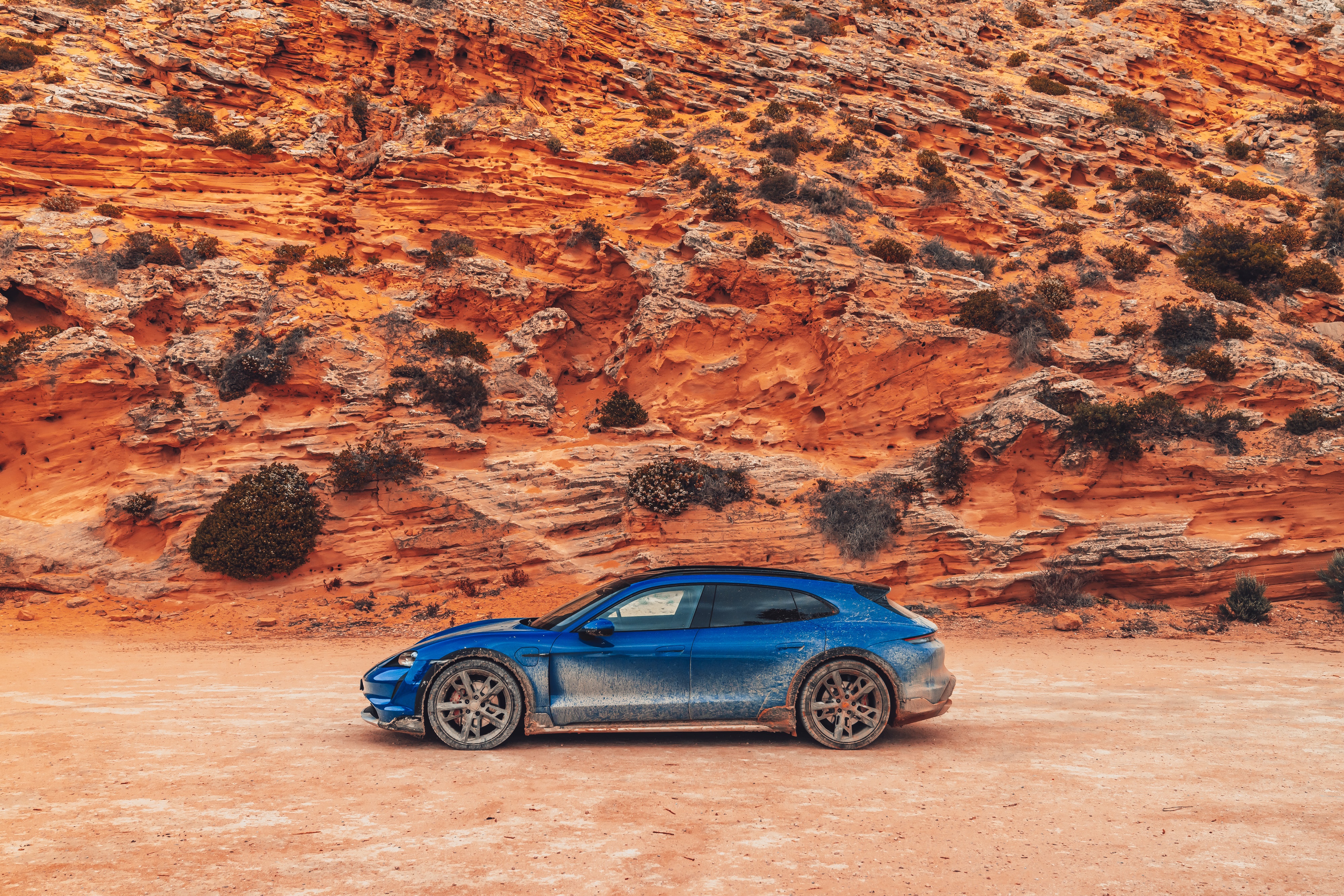 Blue Porsche Taycan 4S Cross Turismo on dirt road HD Wallpaper