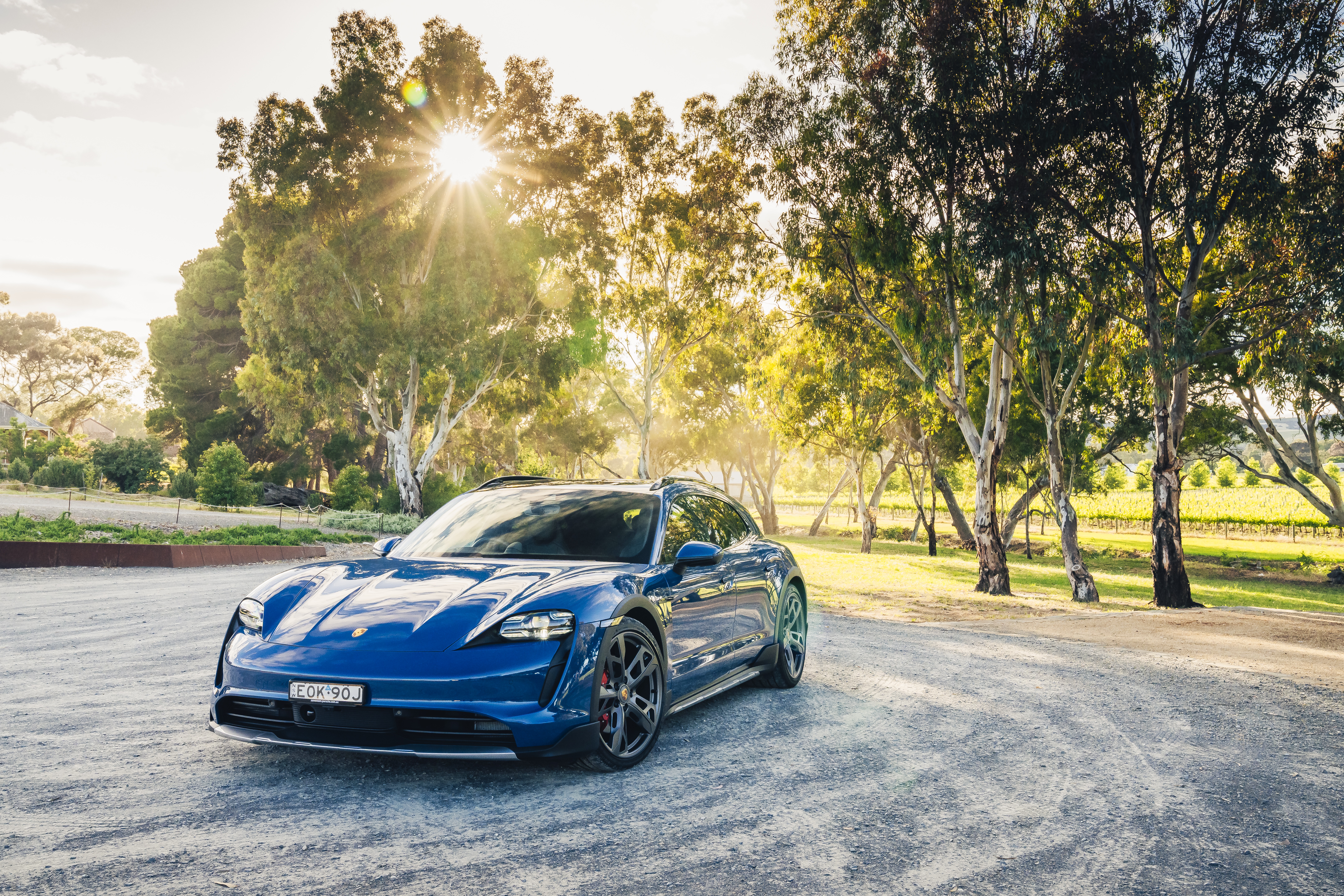 Blue Porsche Taycan 4S Cross Turismo parked outdoors HD Wallpaper