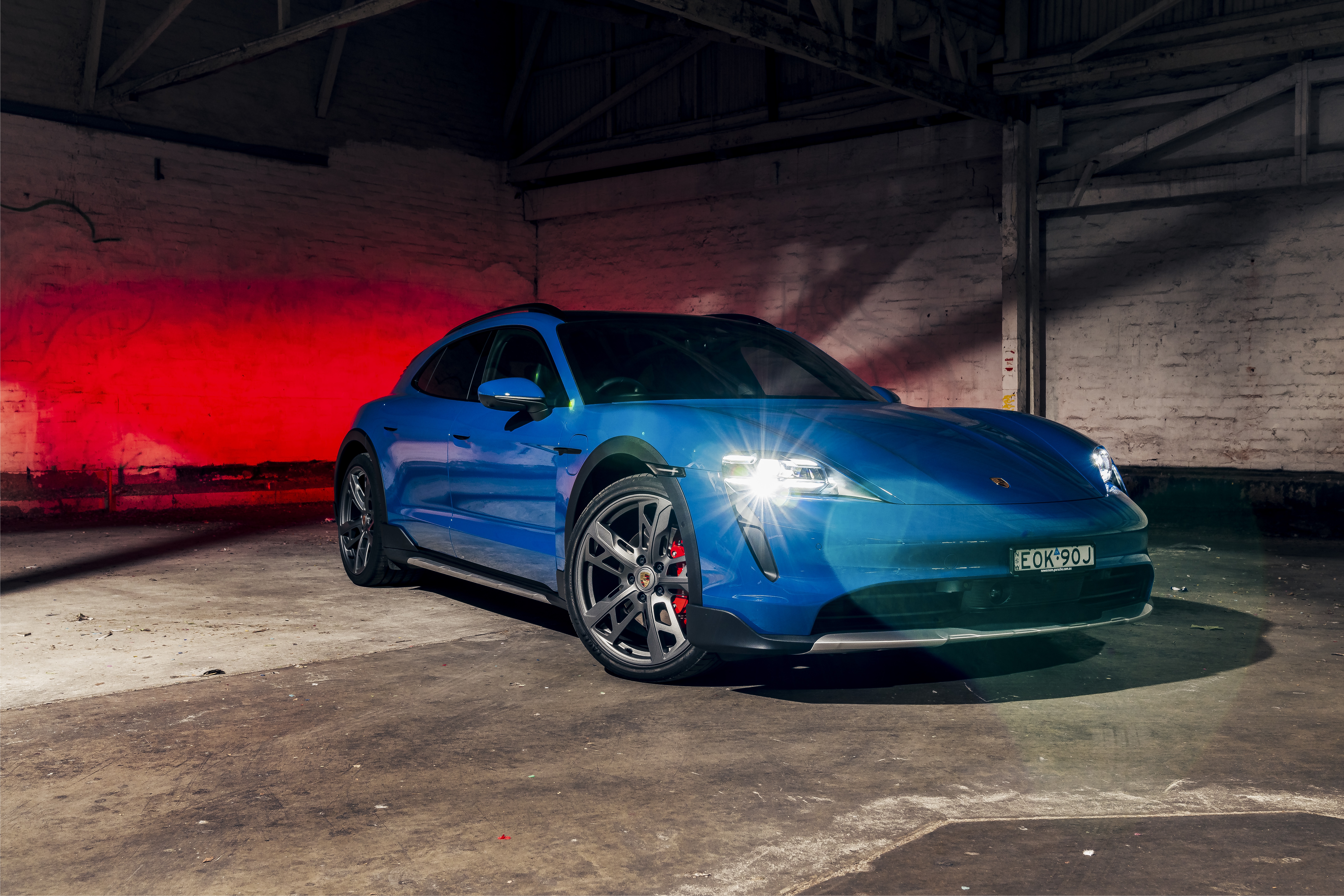 Blue Porsche Taycan 4S Cross Turismo in warehouse HD Wallpaper