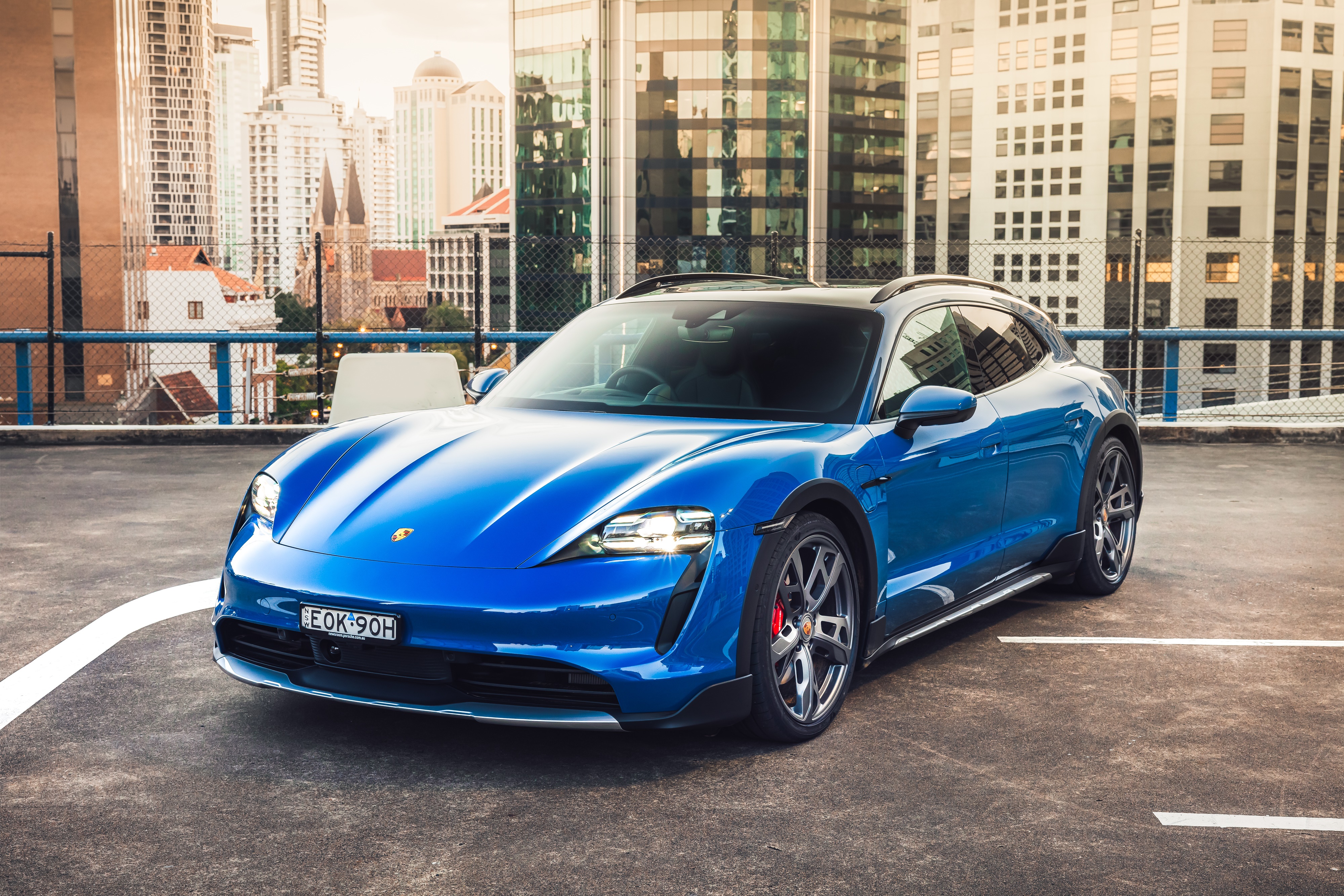 Blue Porsche Taycan 4S Cross Turismo parked in city HD Wallpaper