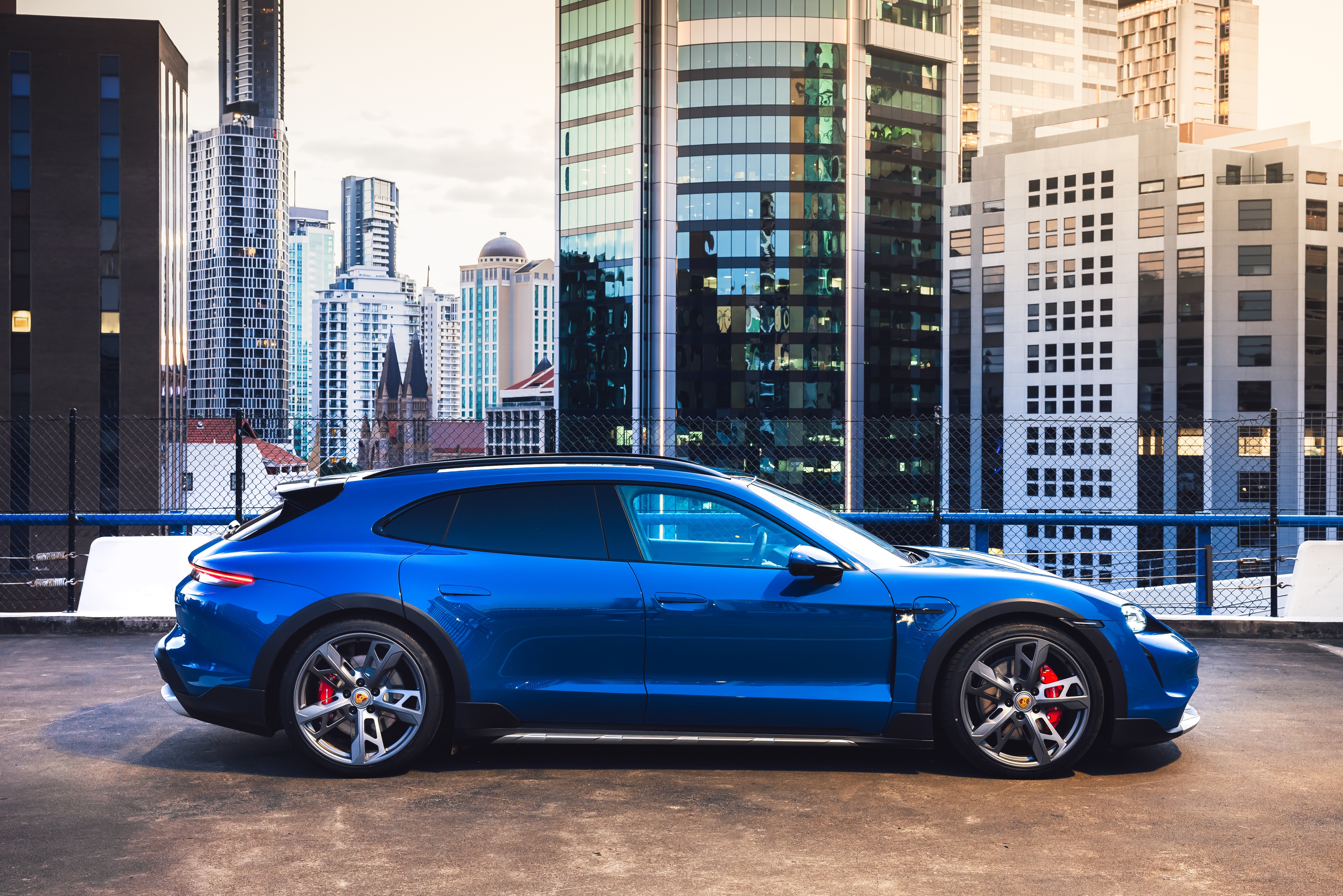 Blue Porsche Taycan 4S Cross Turismo in city HD Wallpaper
