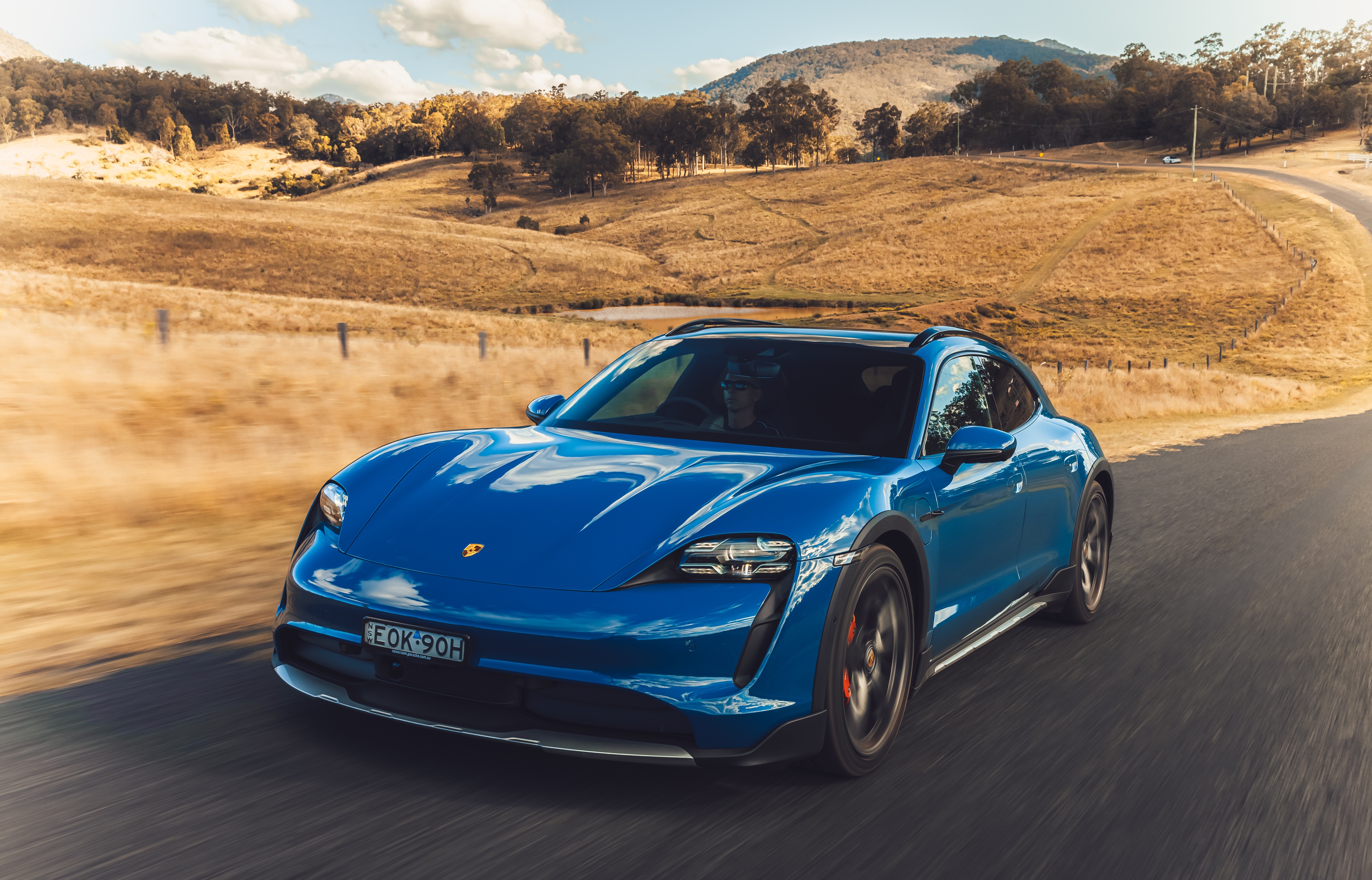 Blue Porsche Taycan 4S Cross Turismo driving on a road HD Wallpaper